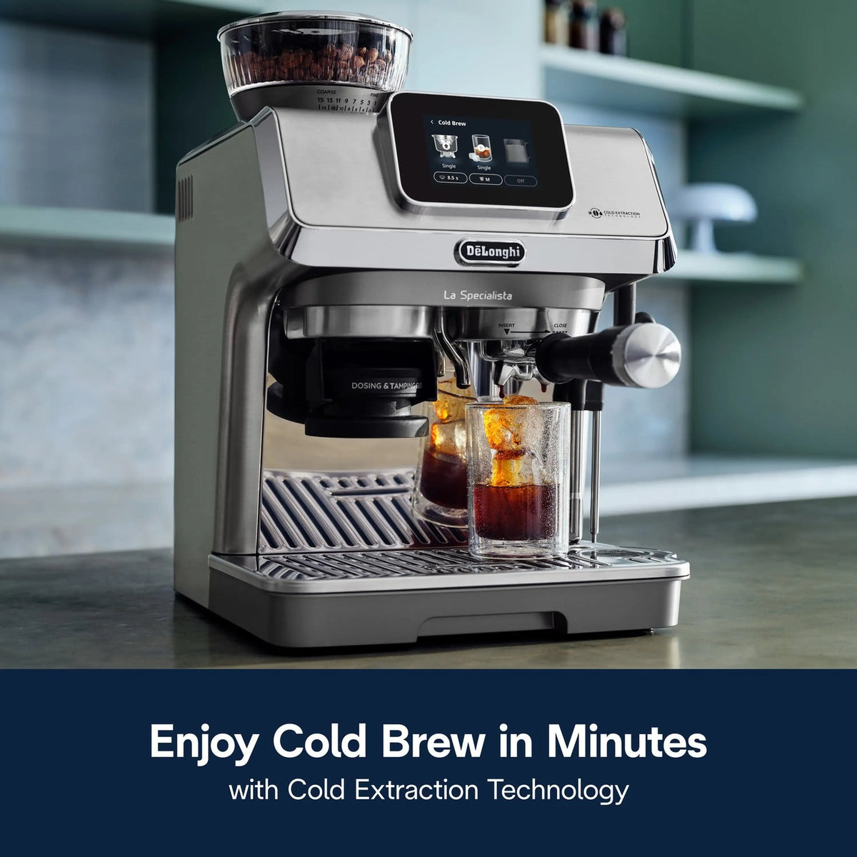 Stainless espresso machine dispensing coffee from the spout into a glass cup for cold brew