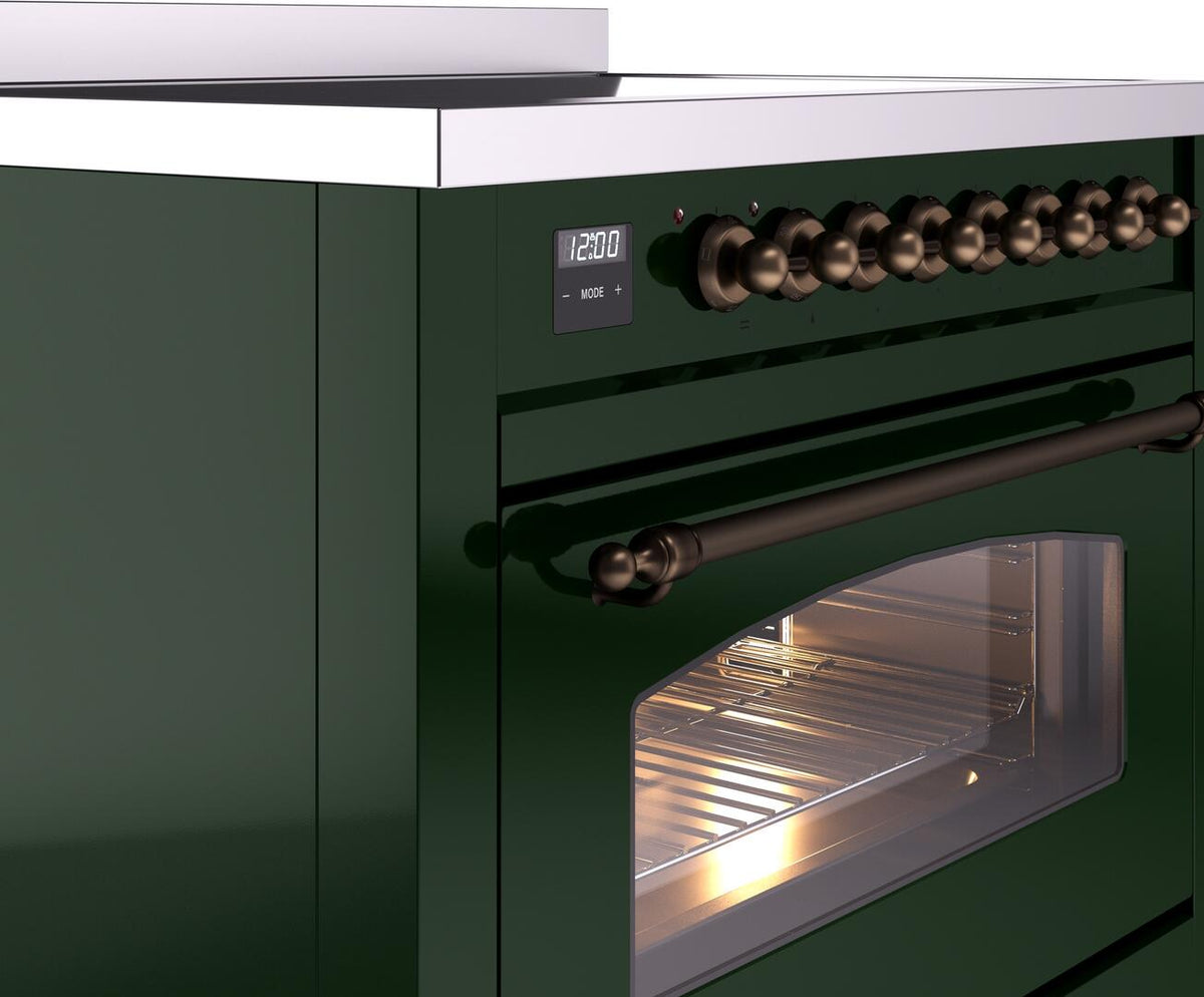 Control knobs and lit oven interior on emerald freestanding electric induction range