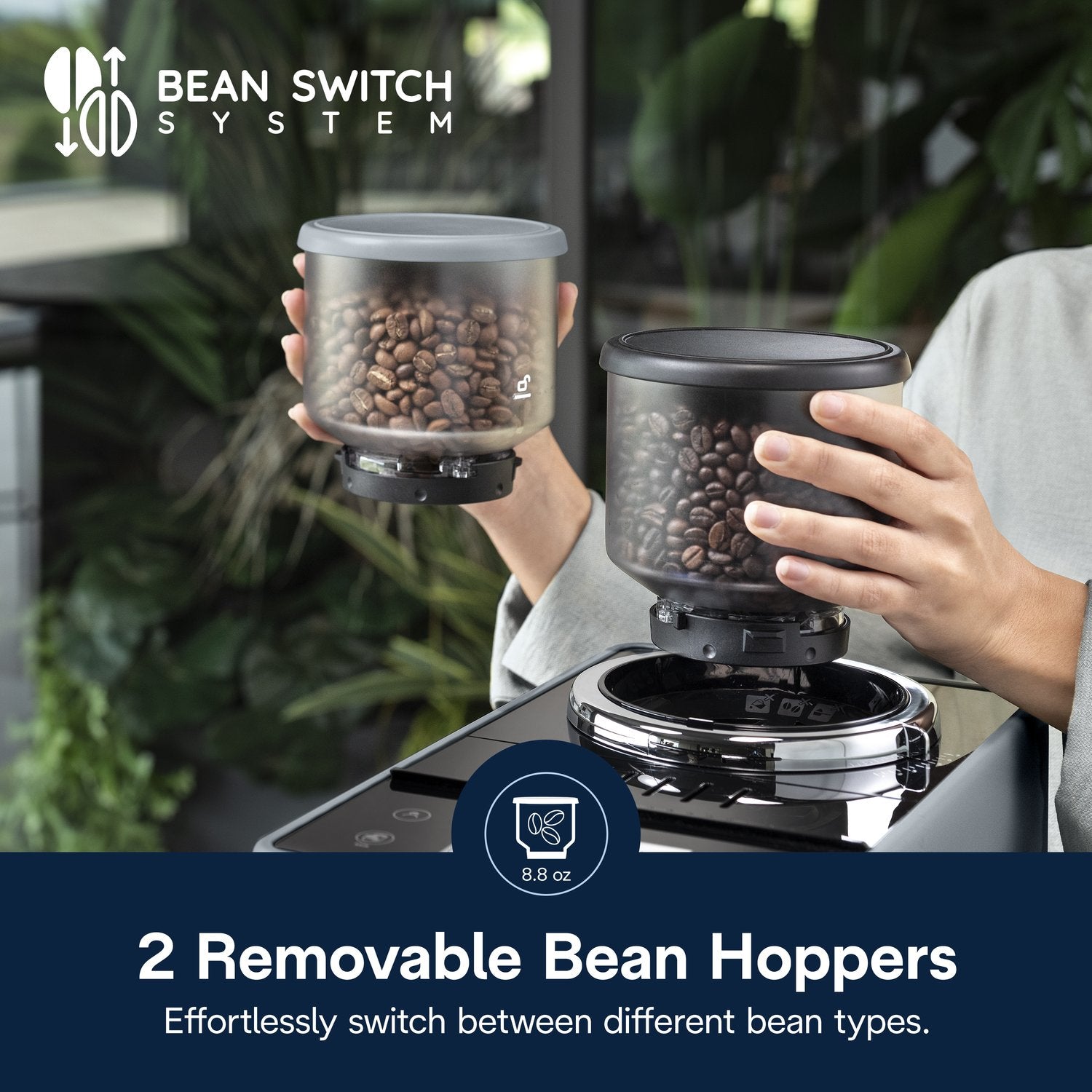 Pebble gray espresso machine showing two removable bean hoppers on the grinder base