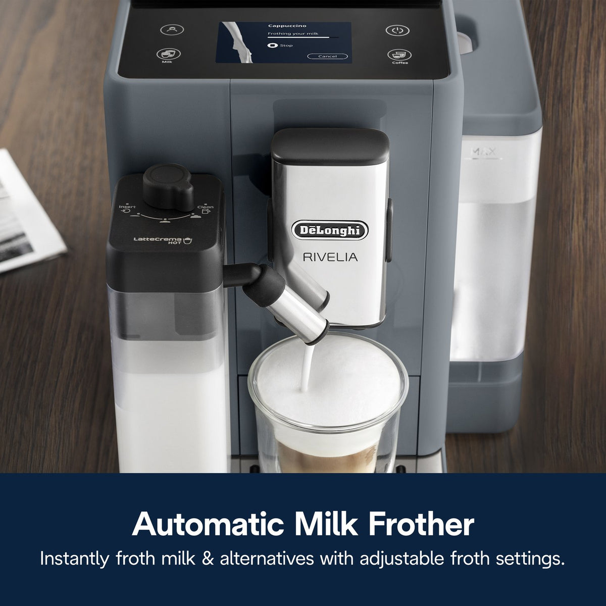 De'Longhi Rivelia automatic milk frother dispensing foam into cup from pebble gray machine