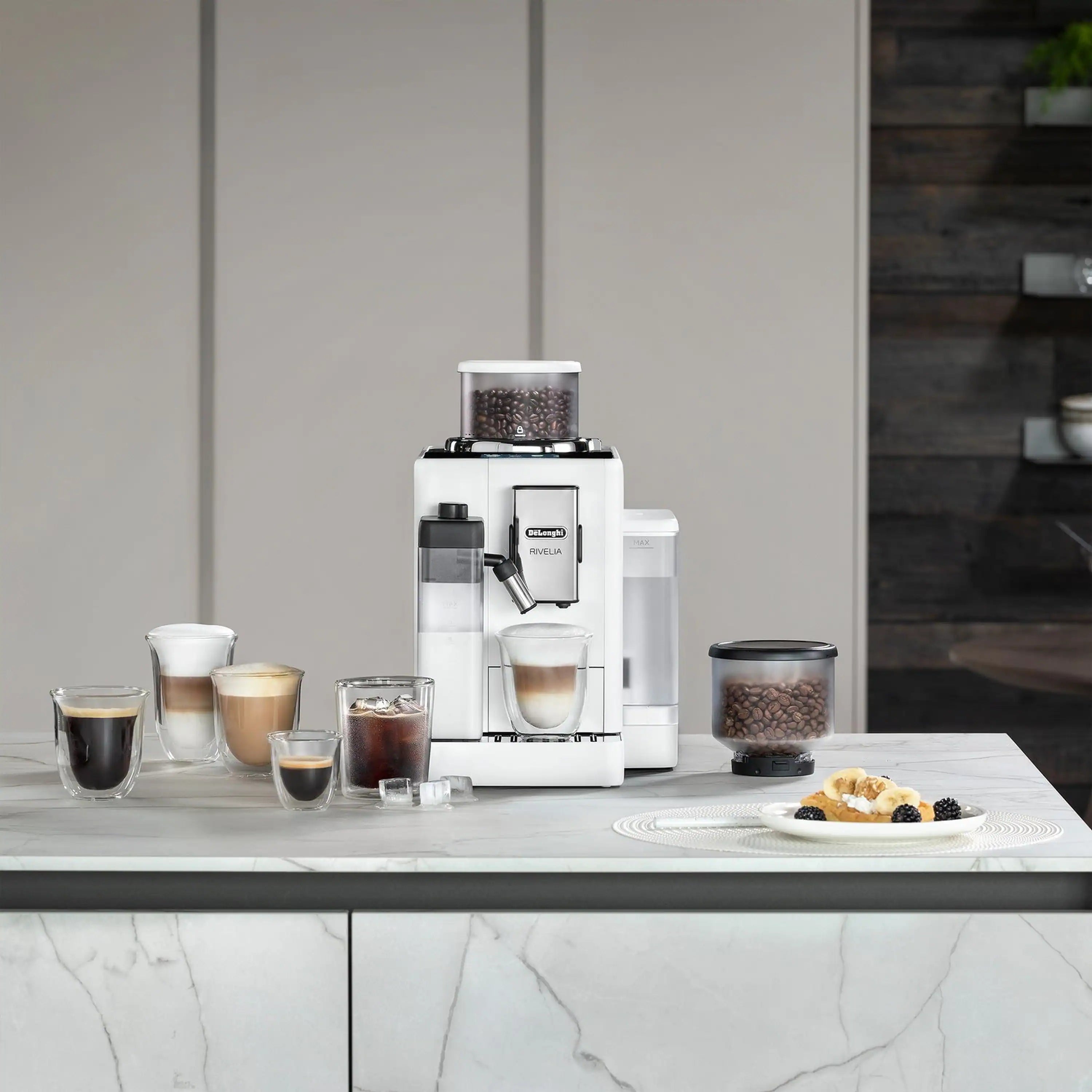 White fully automatic espresso machine on countertop with coffee cups and bean hopper