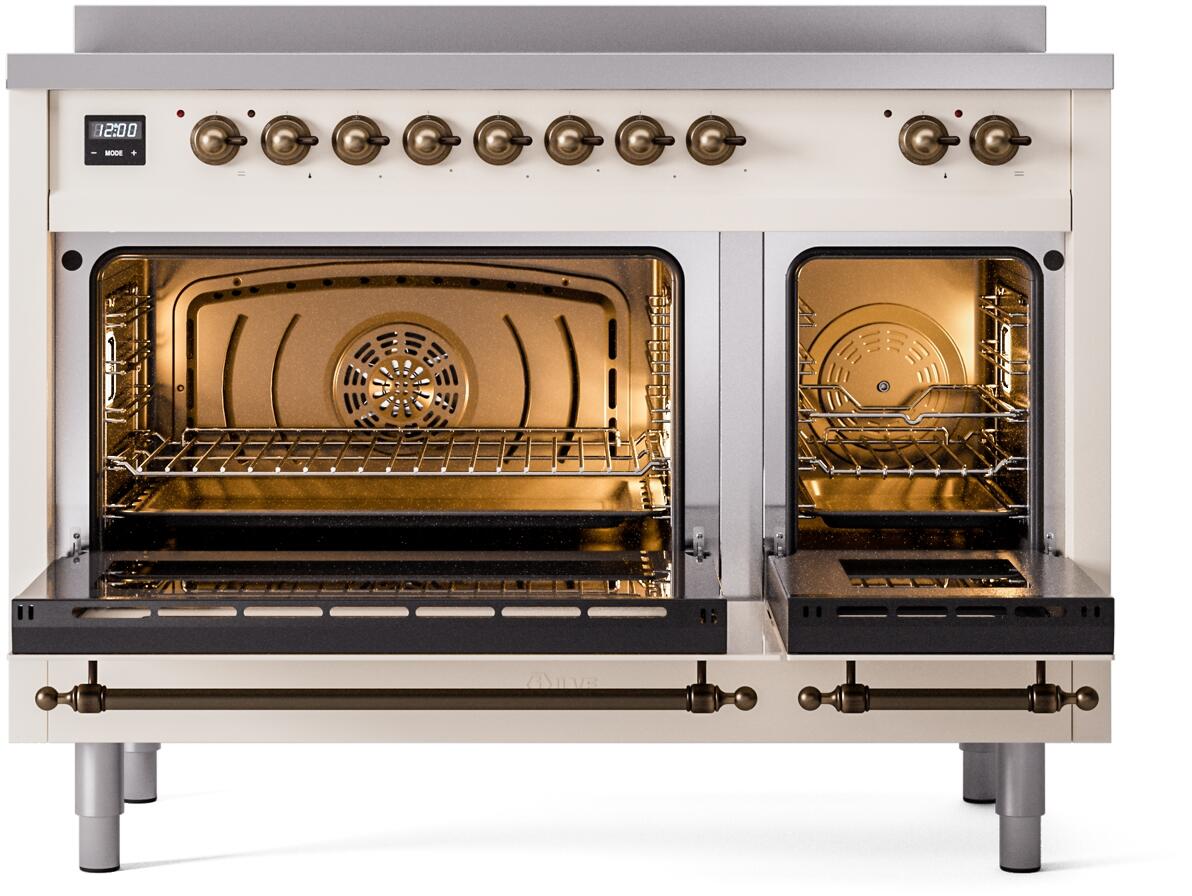 Freestanding electric induction range with both oven doors open, warm interior lighting