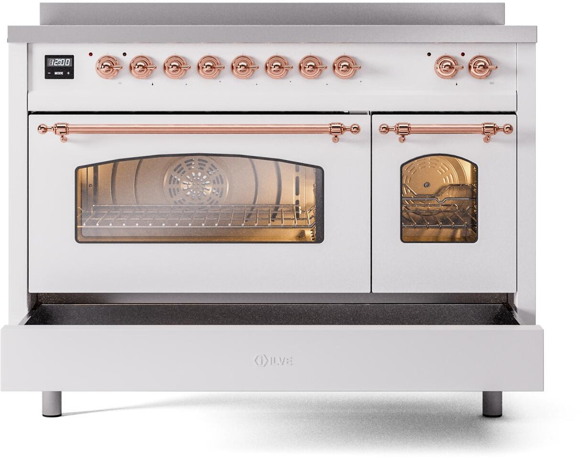 White freestanding induction range front view with glass oven windows and copper knobs