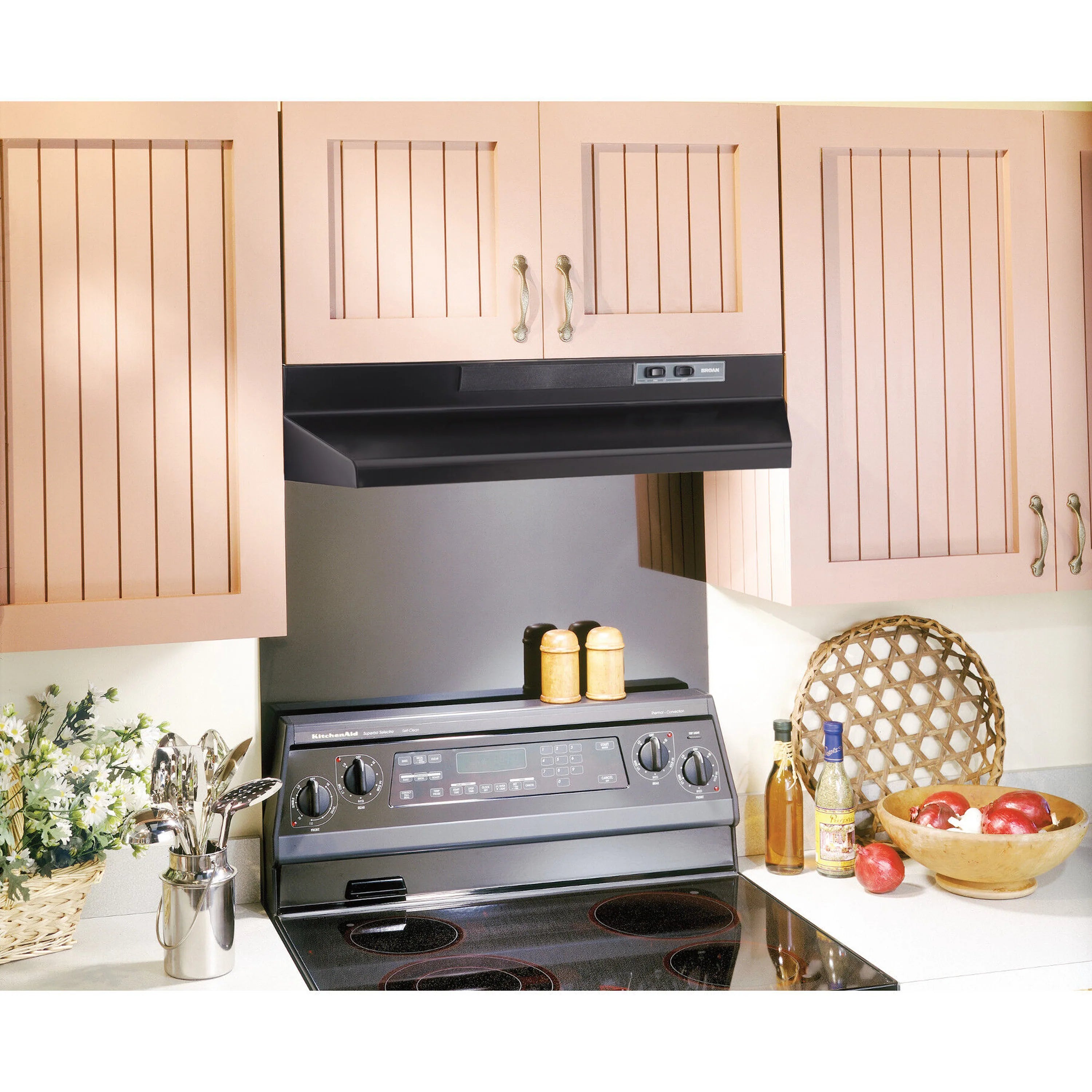 Black under-cabinet range hood installed above a cooktop in a kitchen
