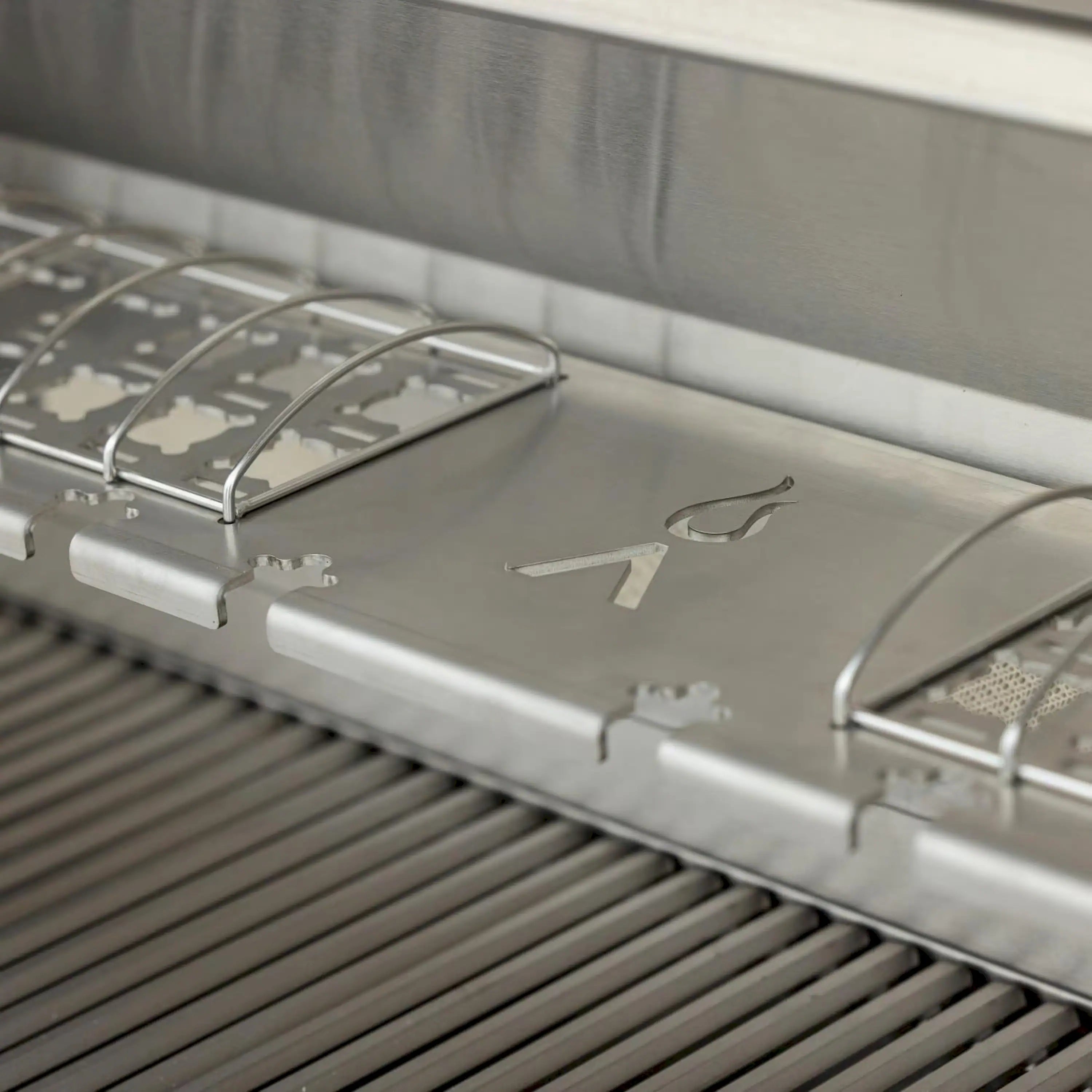 Stainless steel grill cooktop with grates and tool-rest style slots