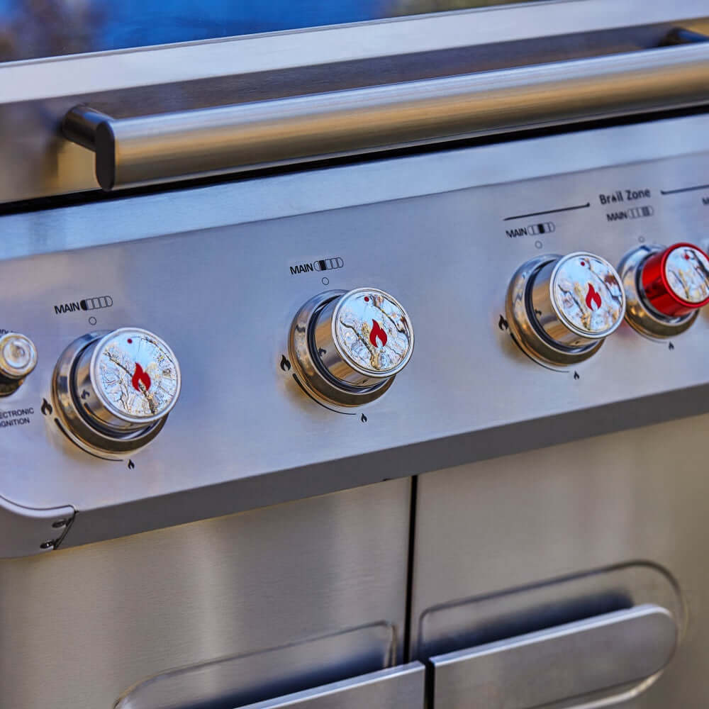 Stainless steel propane gas grill control panel with four burner knobs and burner labels