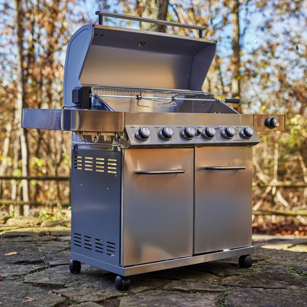 Stainless steel propane gas grill with open lid, control knobs, and cooking area