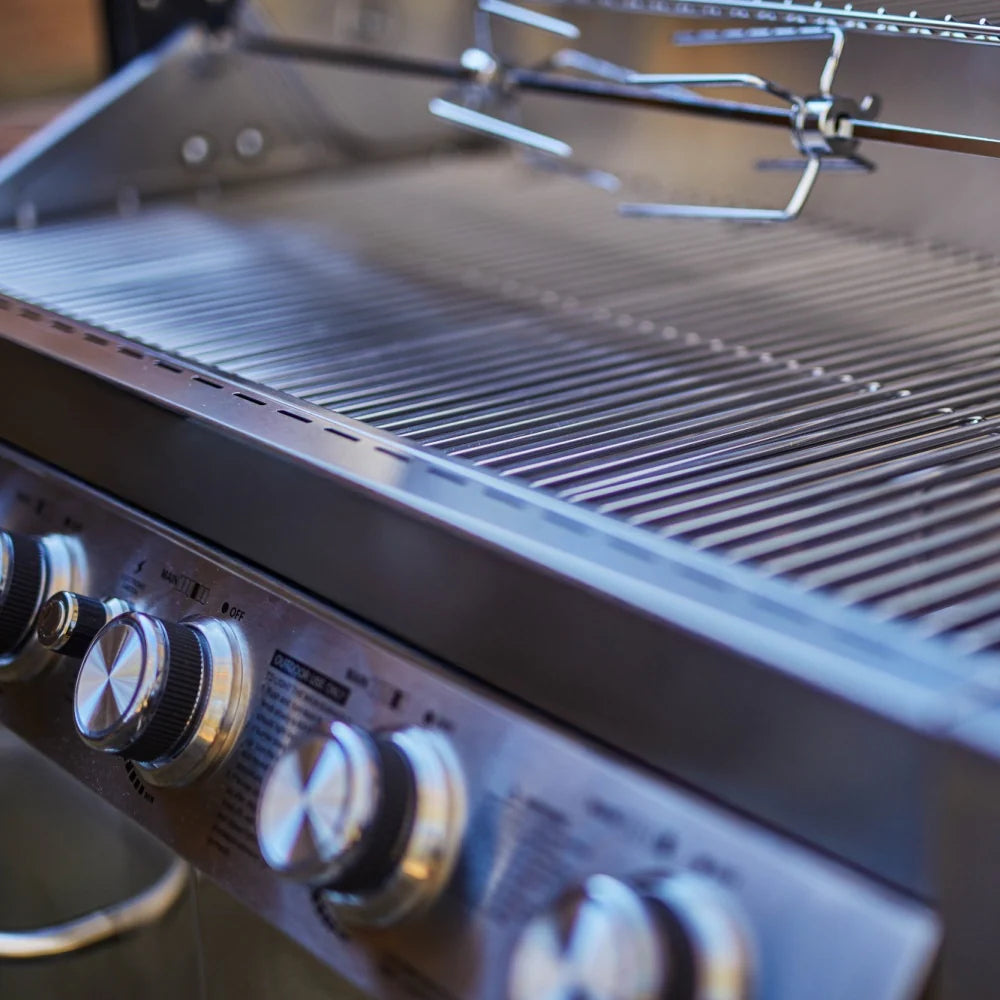Stainless steel propane gas grill front burner knobs in close-up