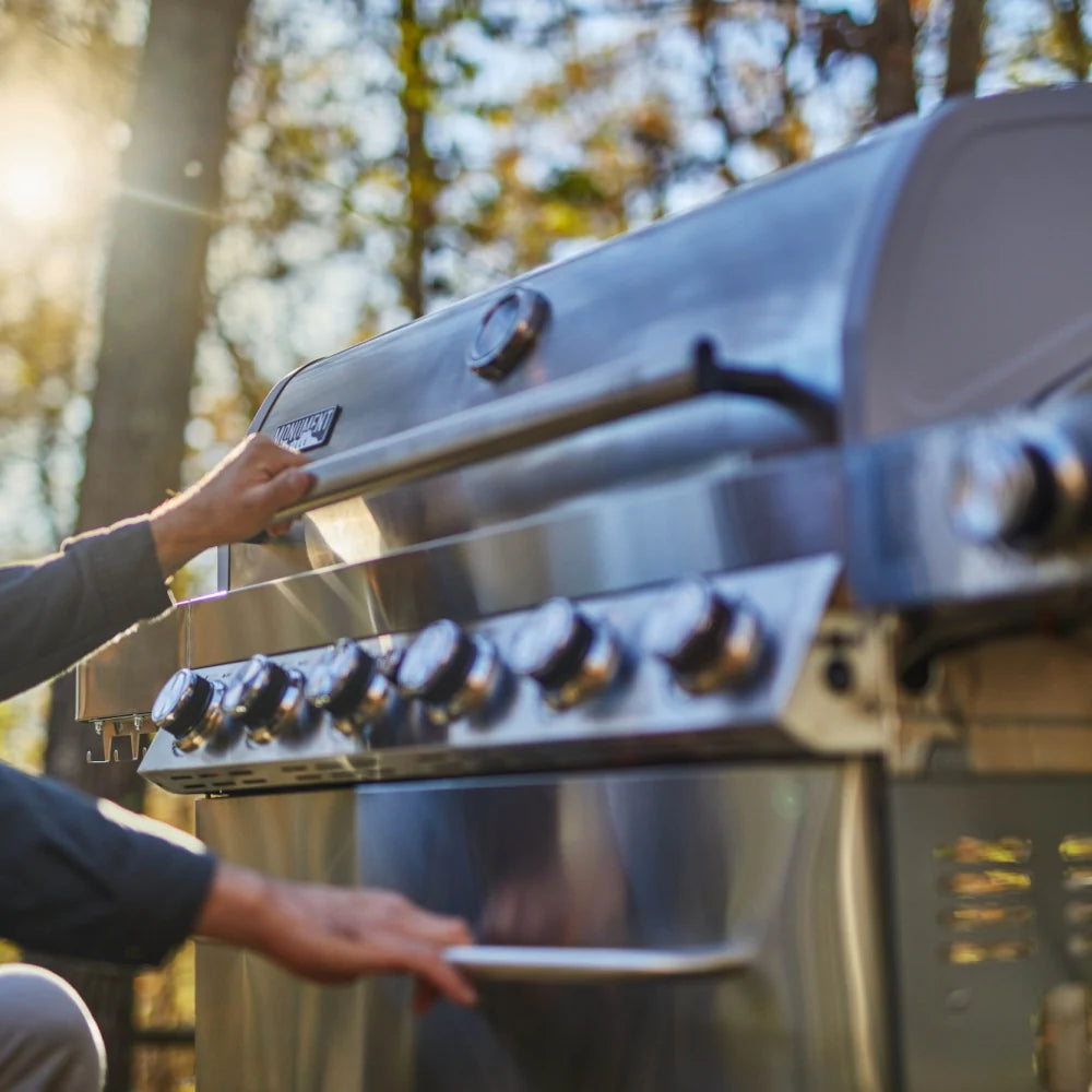 Stainless steel 6-burner propane gas grill with front control knobs and open lid