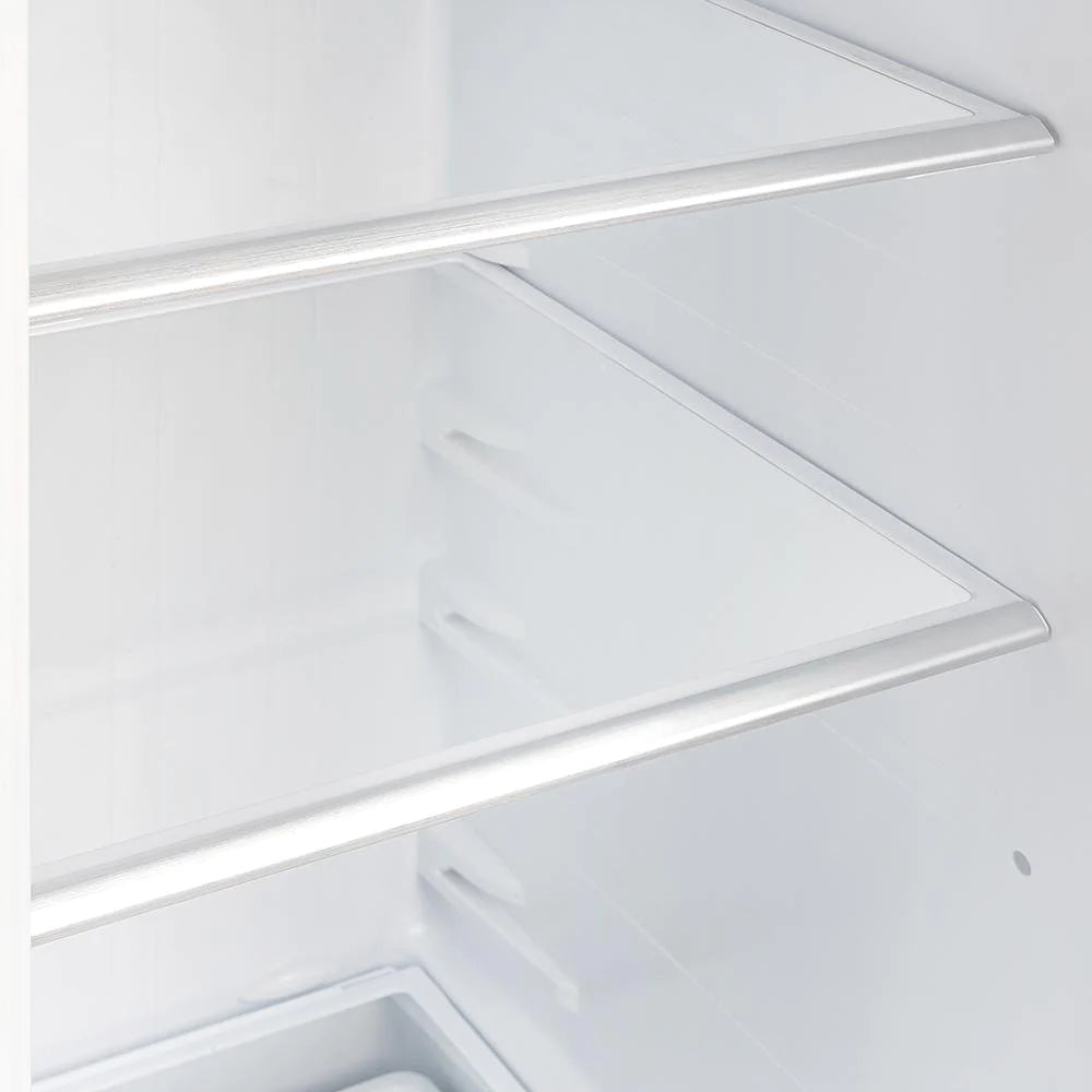 Interior freezer shelf area with white walls and two front ledges, close-up.