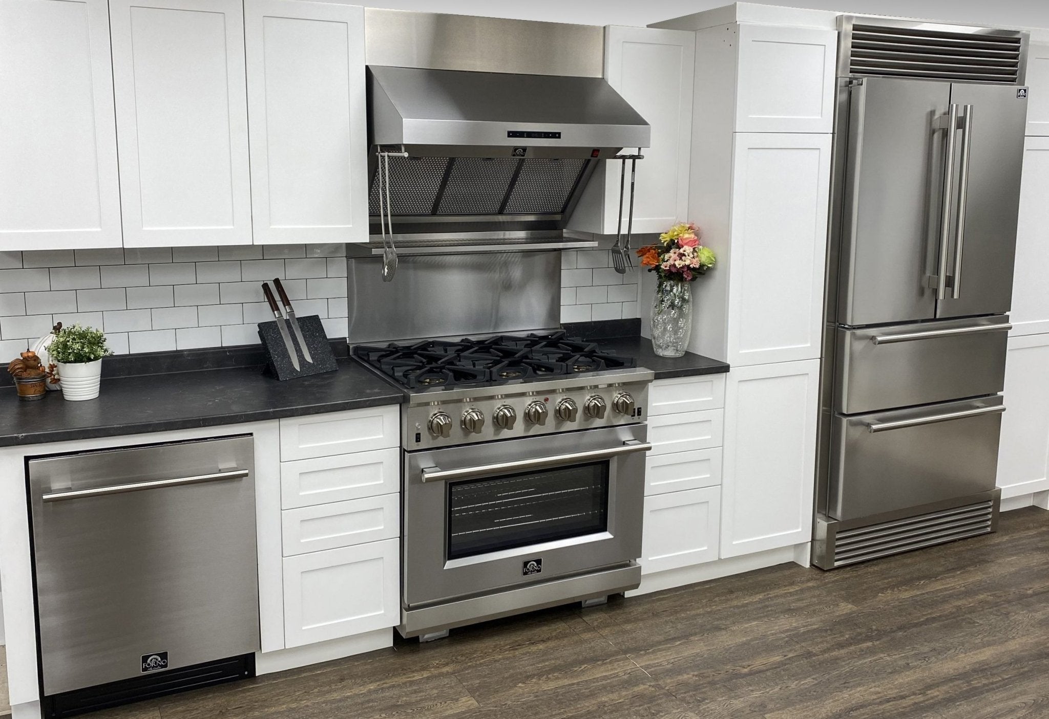 Stainless steel gas range and stainless French door refrigerator in white kitchen