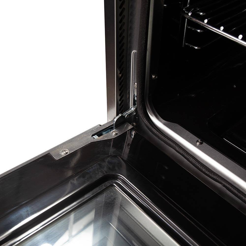 Dual fuel range oven interior corner with metal support rails and heating element
