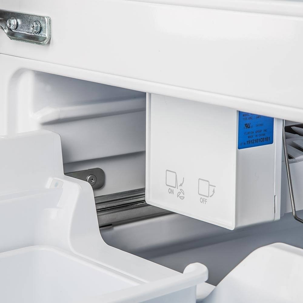 White freezer drawer with control icons and interior shelf area