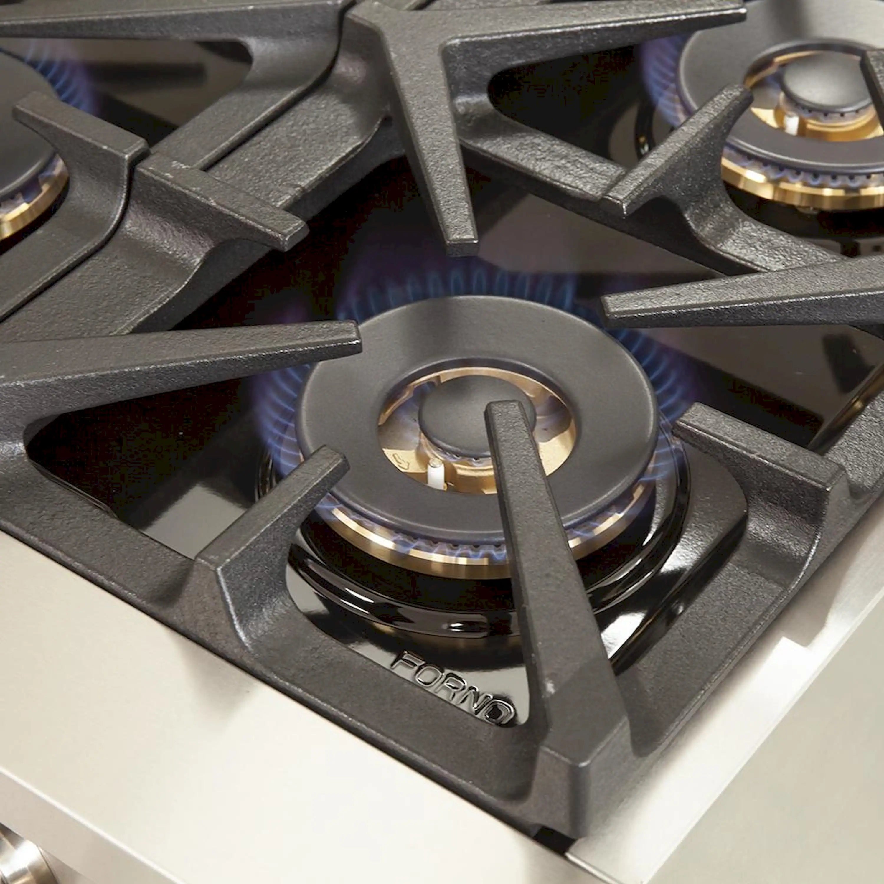 Blue-flame gas burner with cast-iron grate on stainless steel cooktop