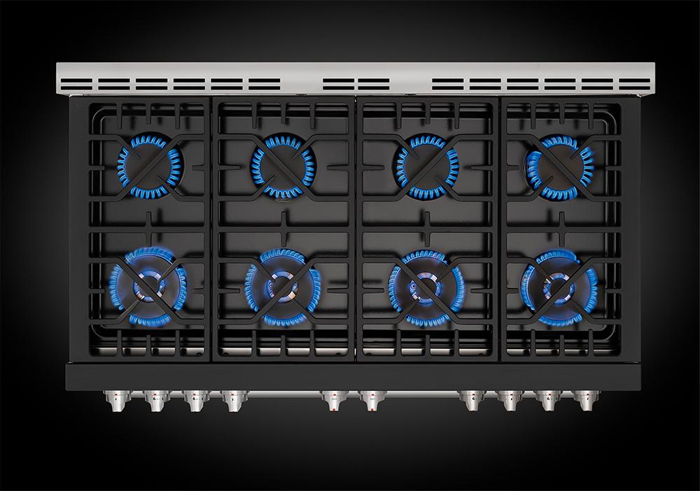 Gas range cooktop with blue-lit burners and black burner grates