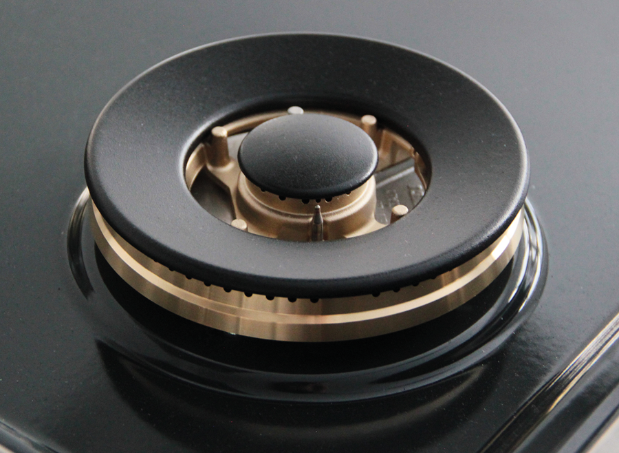 Black burner cap on stainless cooktop