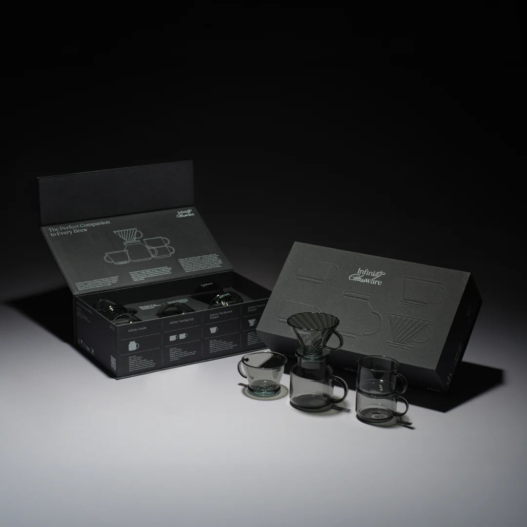 Coffee brewing set components laid out beside an open black instruction box