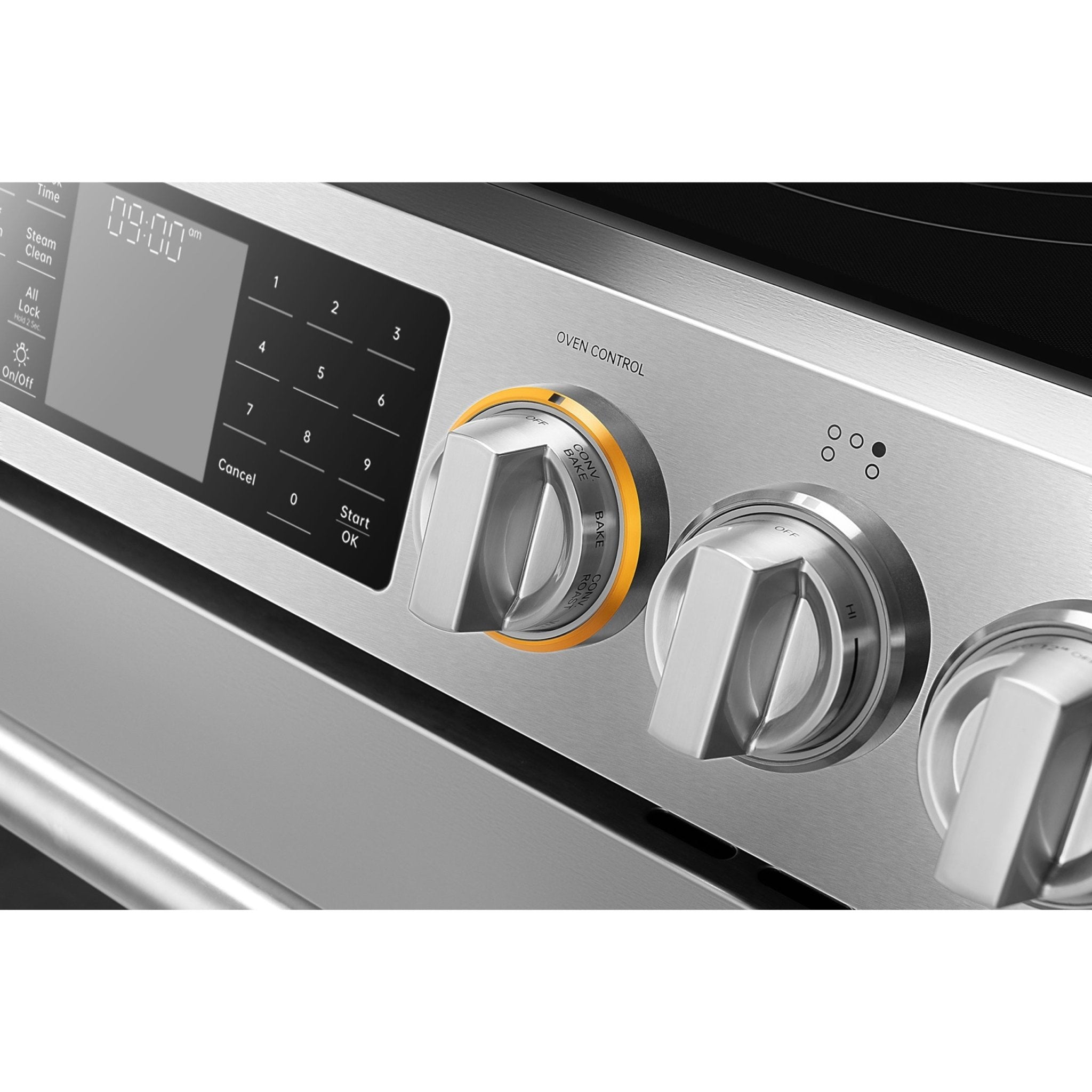 Range control panel close-up with digital display and silver plus yellow-lit knobs