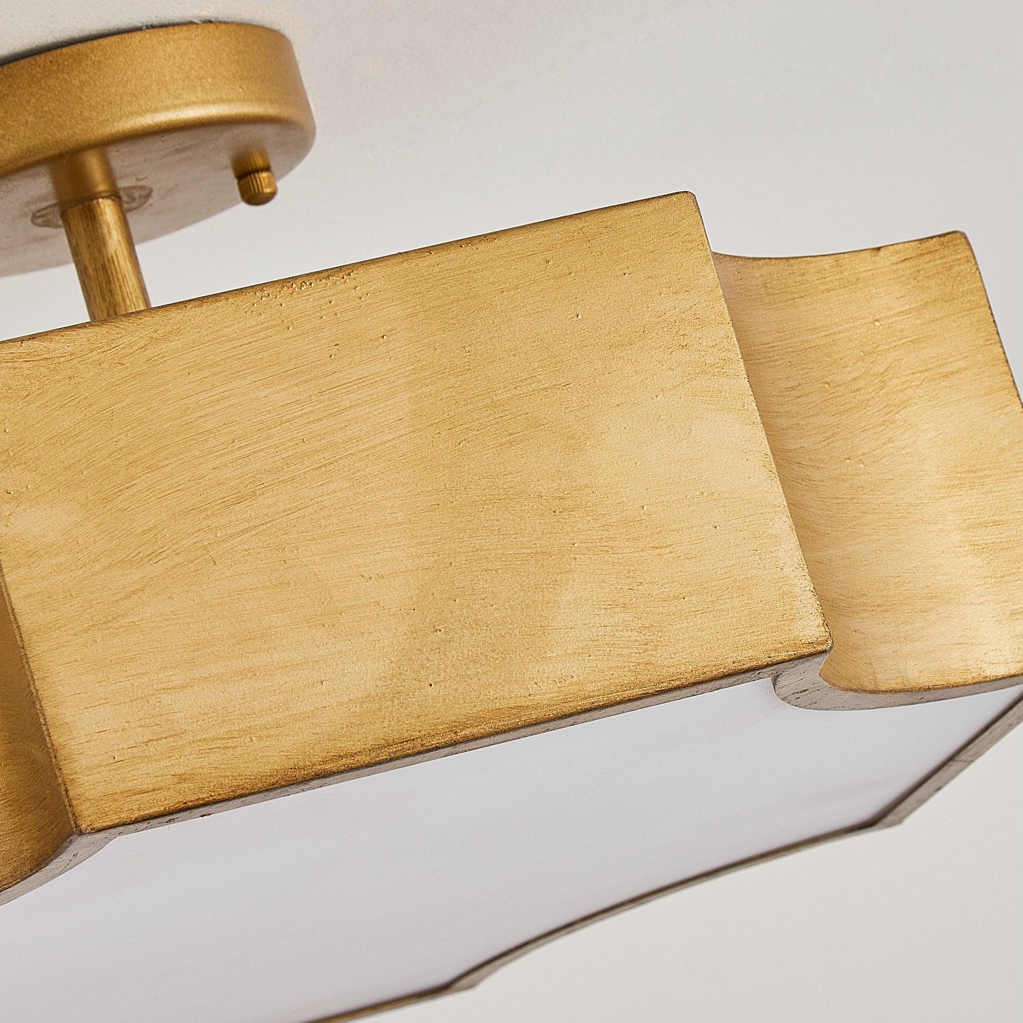 Brushed gold ceiling mount with curved shade edges and white acrylic bottom panel
