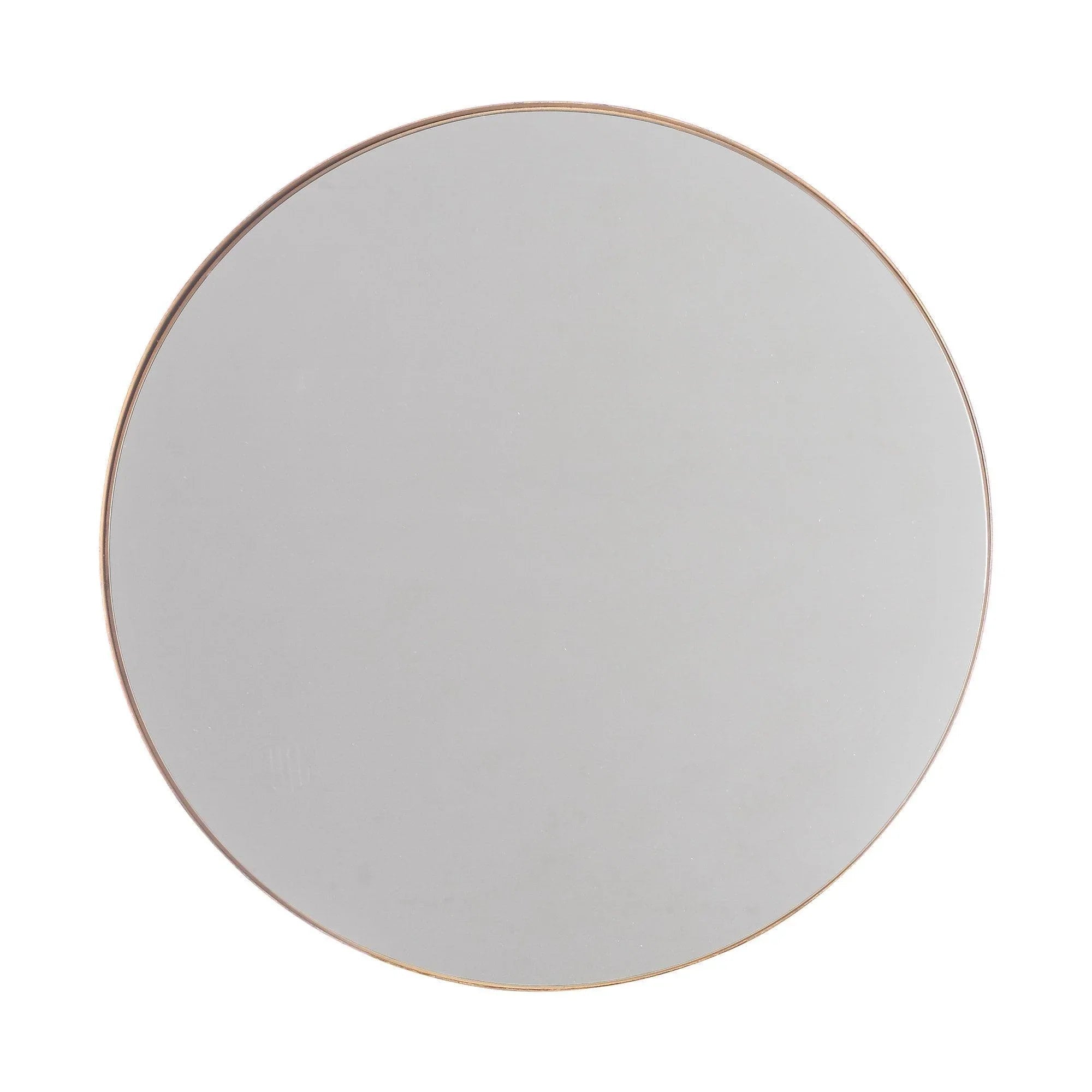 Round wall mirror with thin golden metal frame and clear glass front.