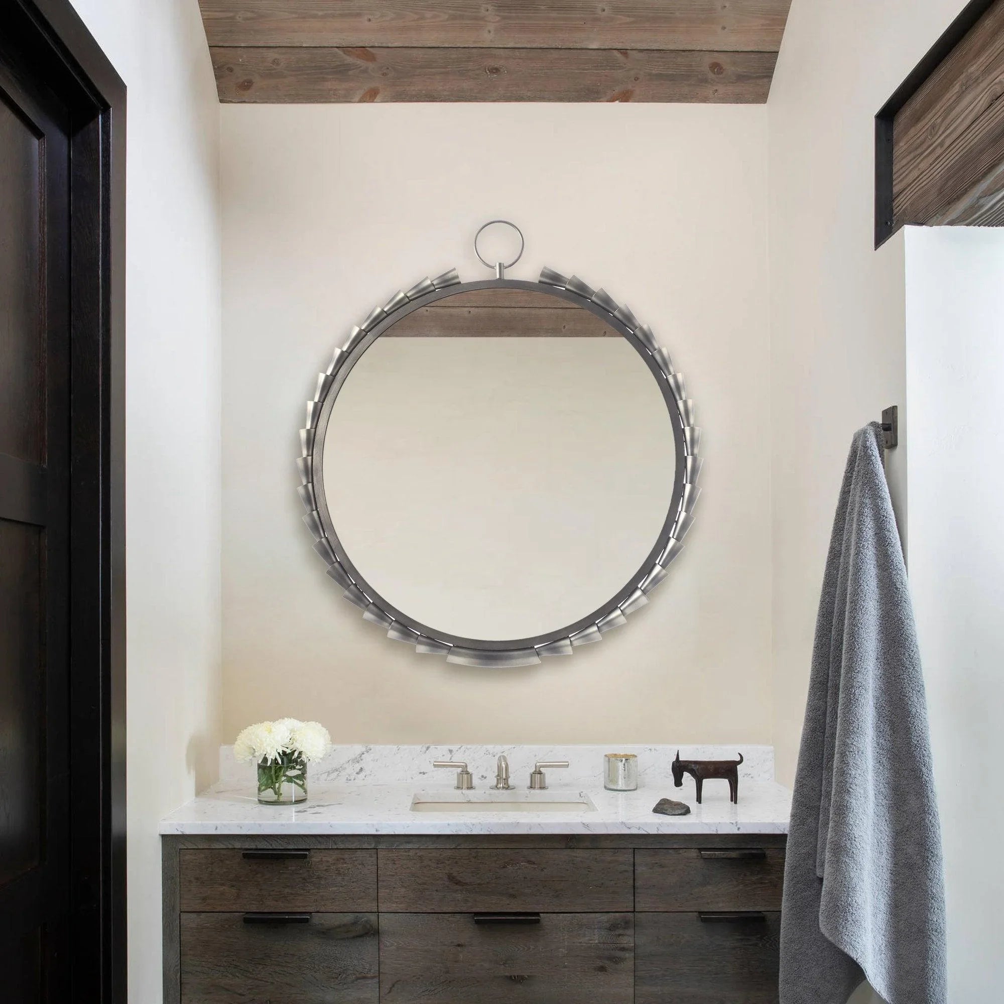 Round grey wall mirror with metallic tab frame and hanging ring