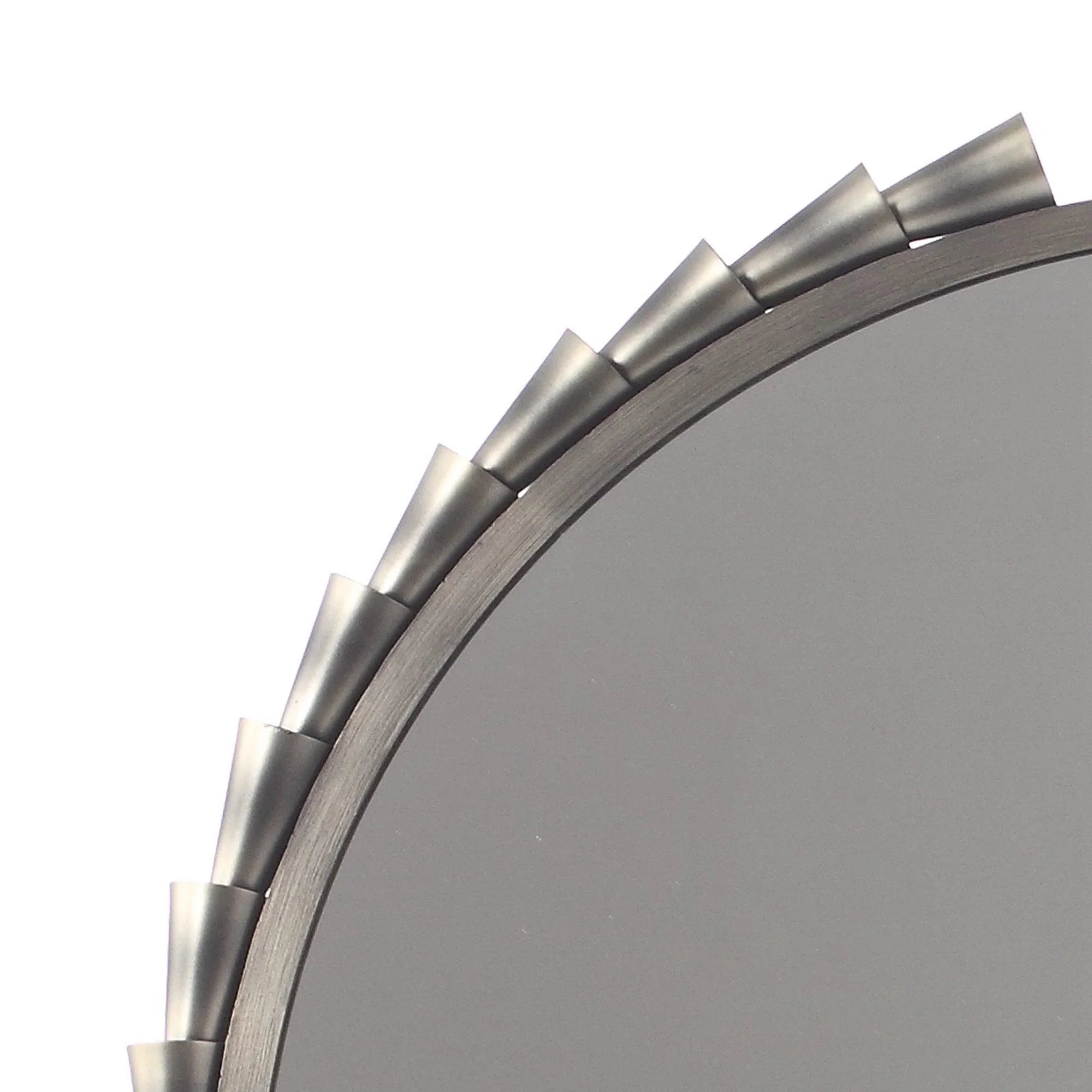 Metallic tab border detail on grey round wall mirror