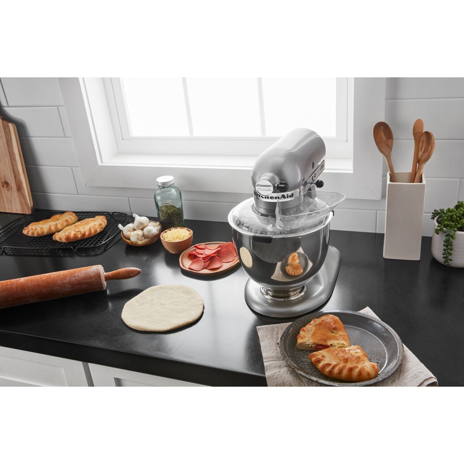 Contour silver stand mixer with stainless bowl and dough ingredients on counter