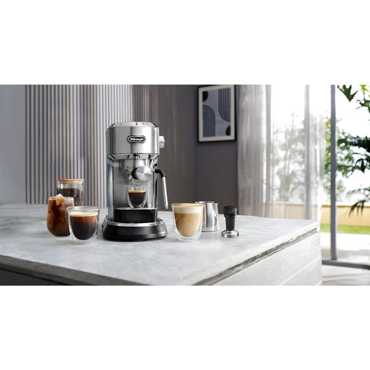 Stainless steel espresso machine on a countertop with cups of espresso and milk drinks