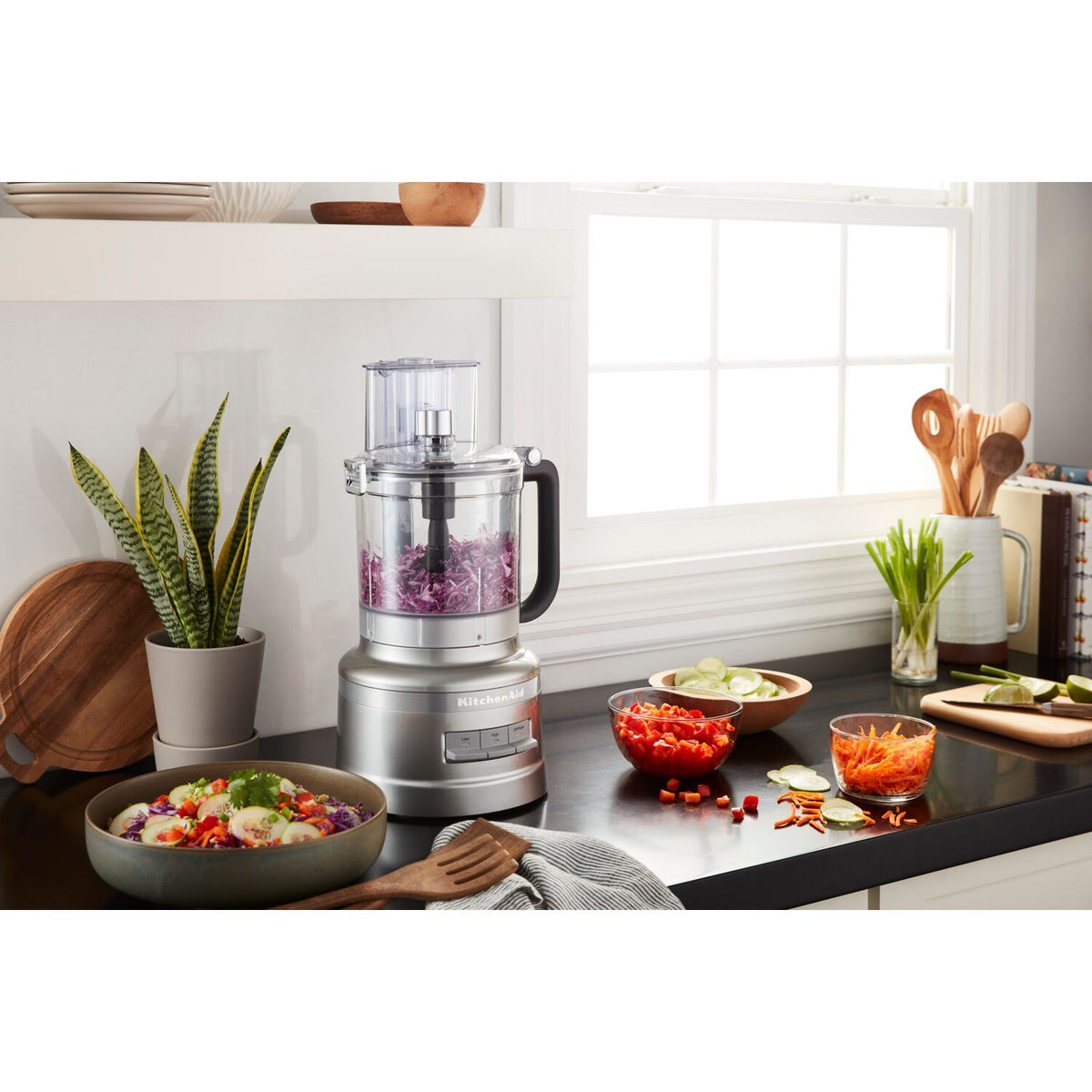 13-cup food processor with clear work bowl, silver base, black handle, and lid