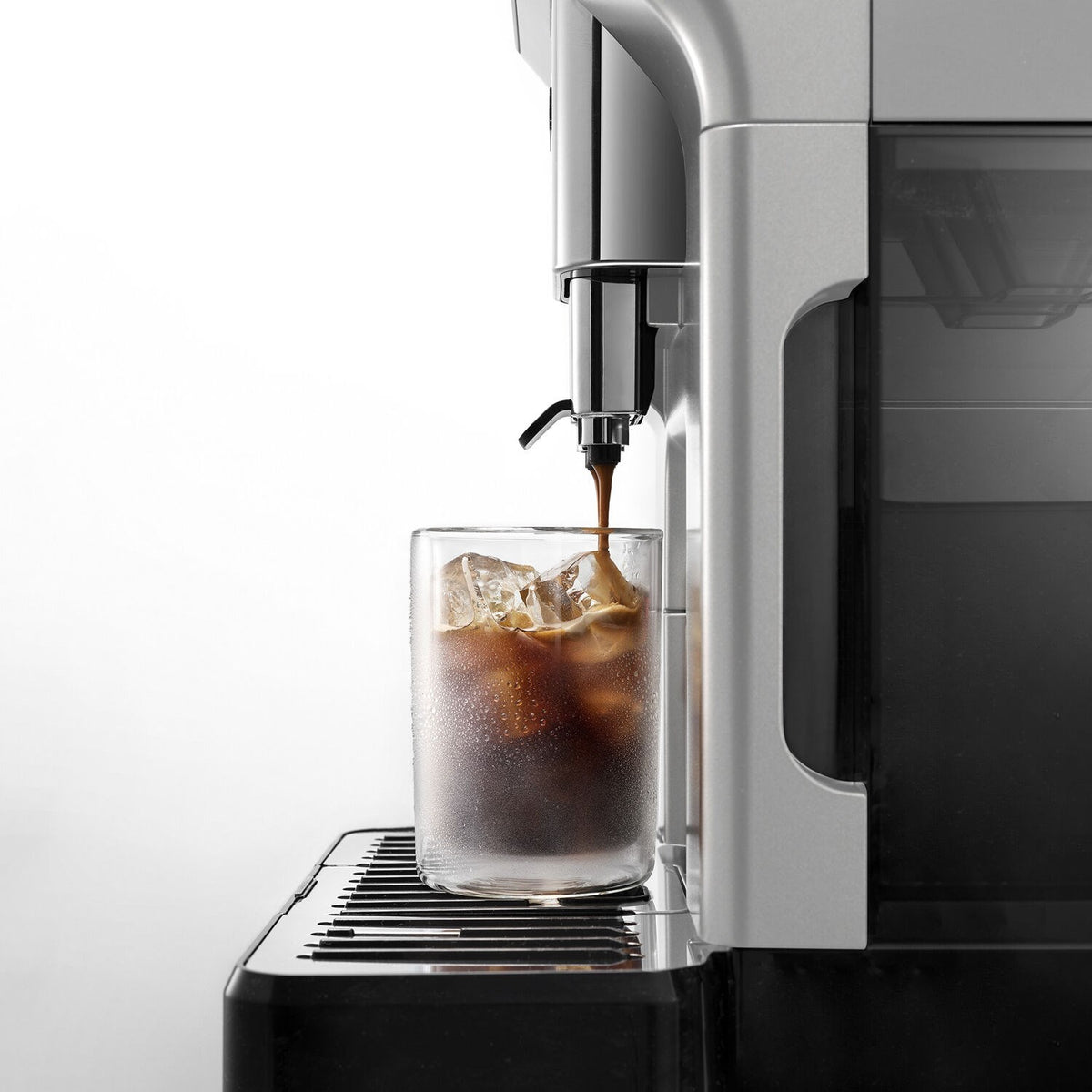 Cold brew spout on a fully automatic espresso machine filling a clear glass