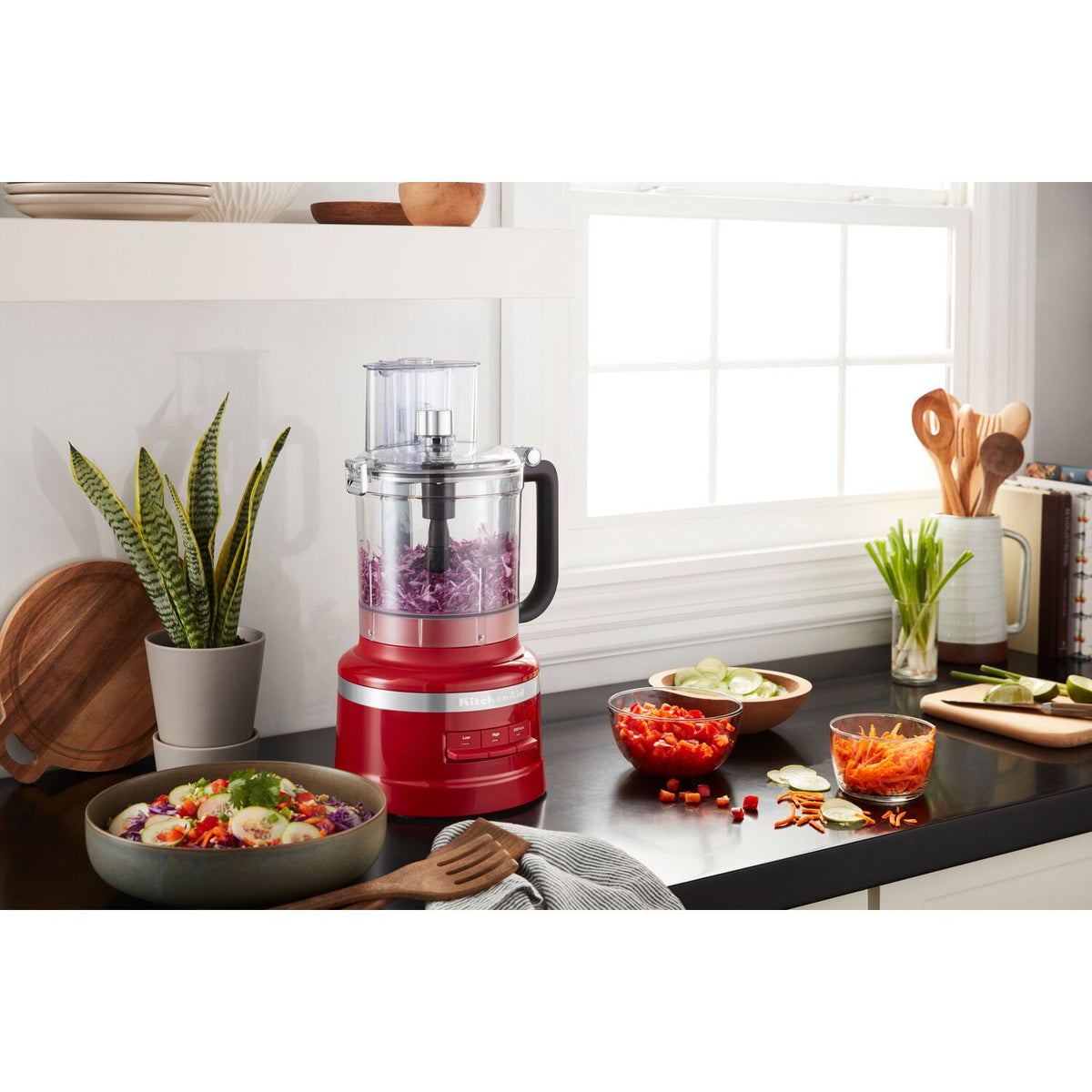 Empire Red KitchenAid food processor with clear bowl and lid, countertop setup