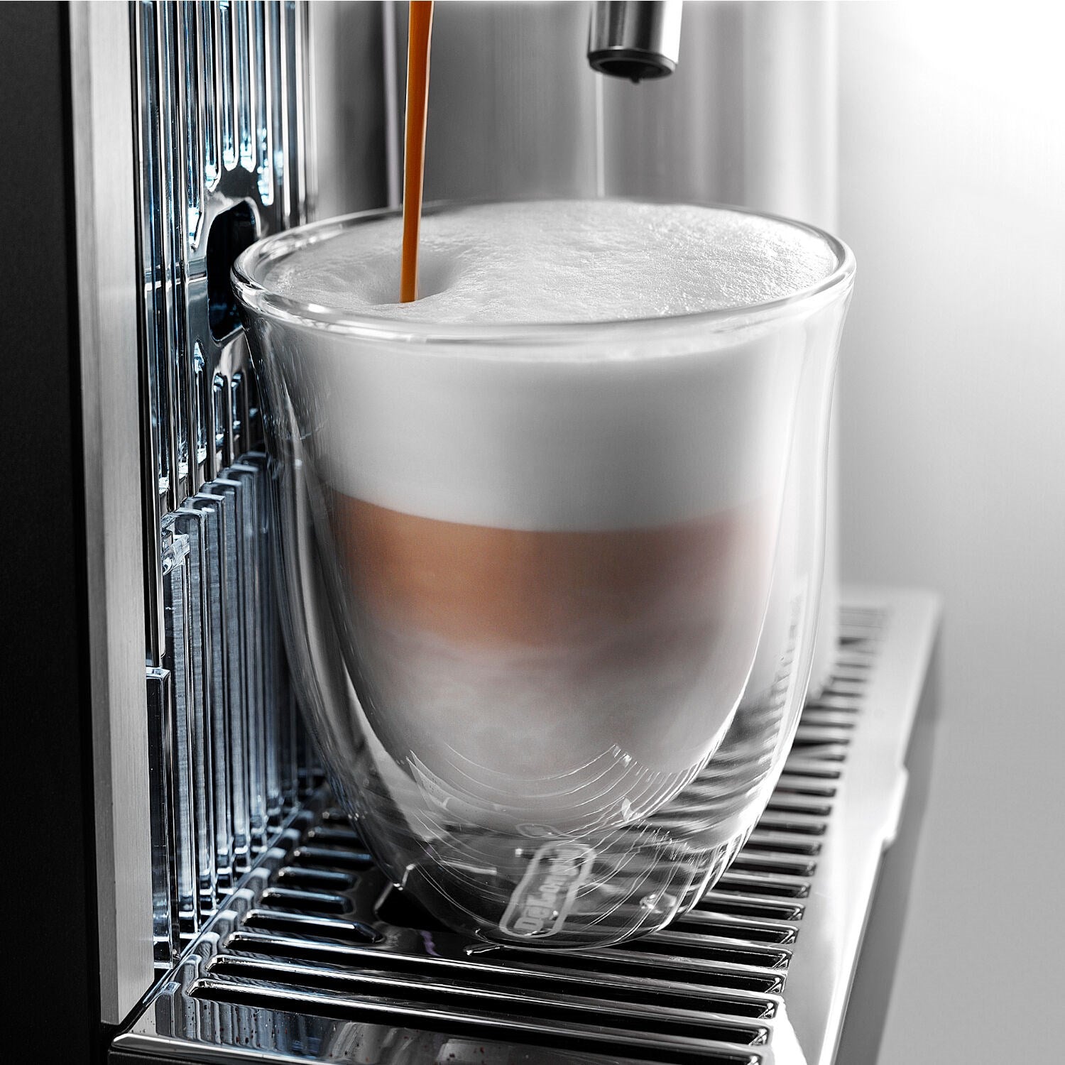 Double-wall thermal cappuccino glass with frothy white drink