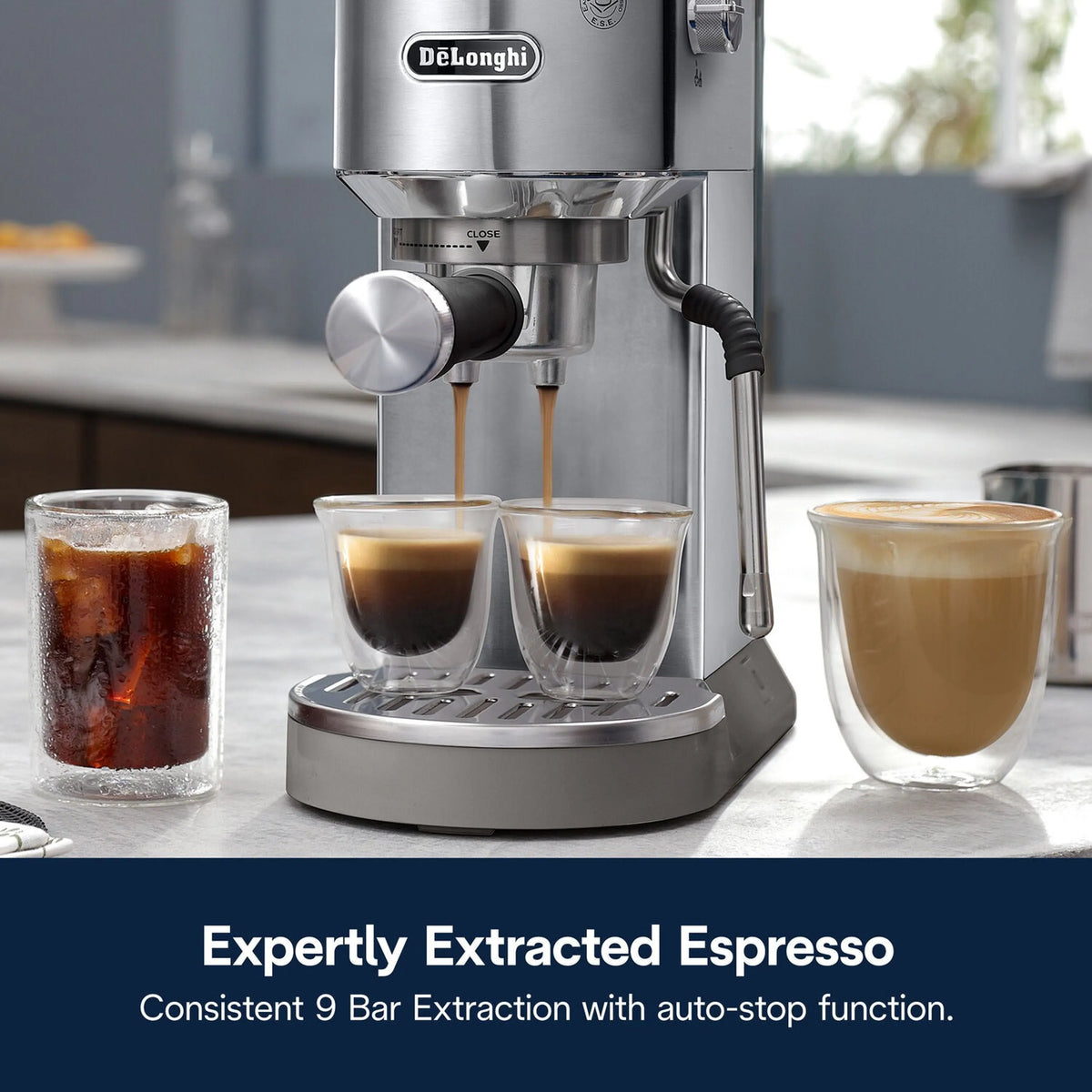 Stainless espresso machine pouring twin shots into cups on drip tray