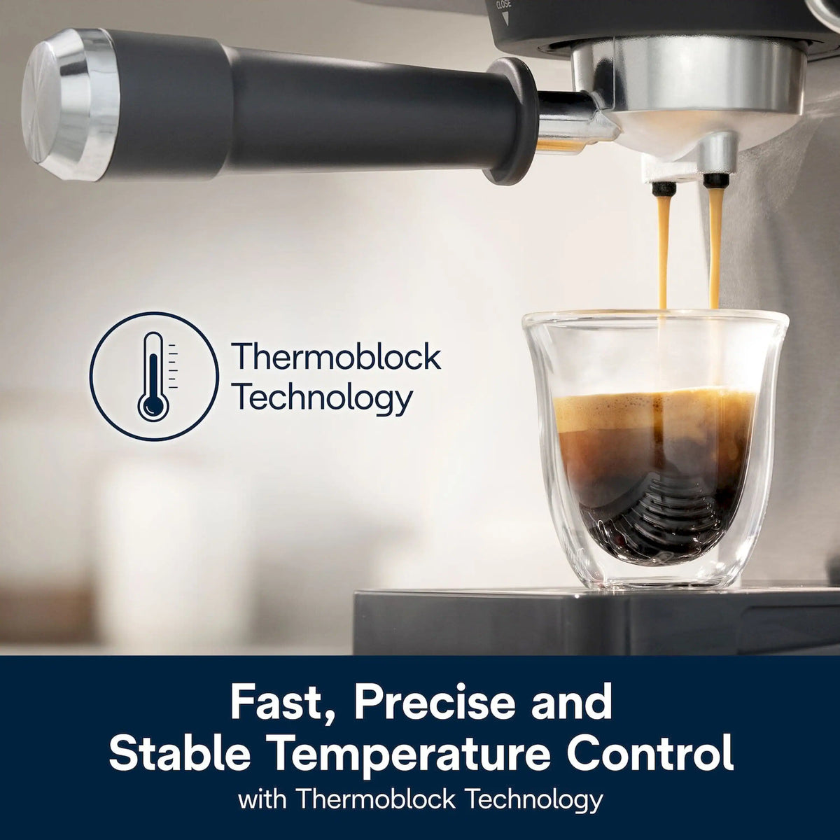 Espresso machine steam wand pouring crema into a clear glass cup