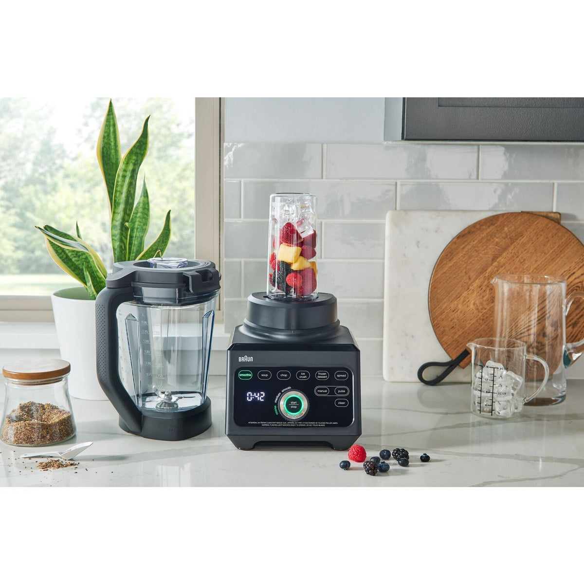 Black Braun blender with tall jar and mixed ingredients beside containers