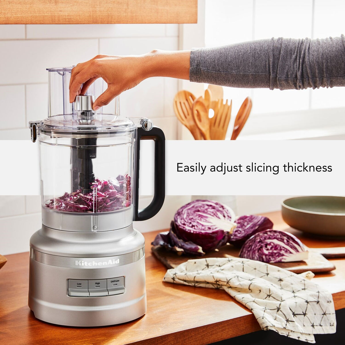 Food processor with clear work bowl, silver base, and black feed chute for slicing