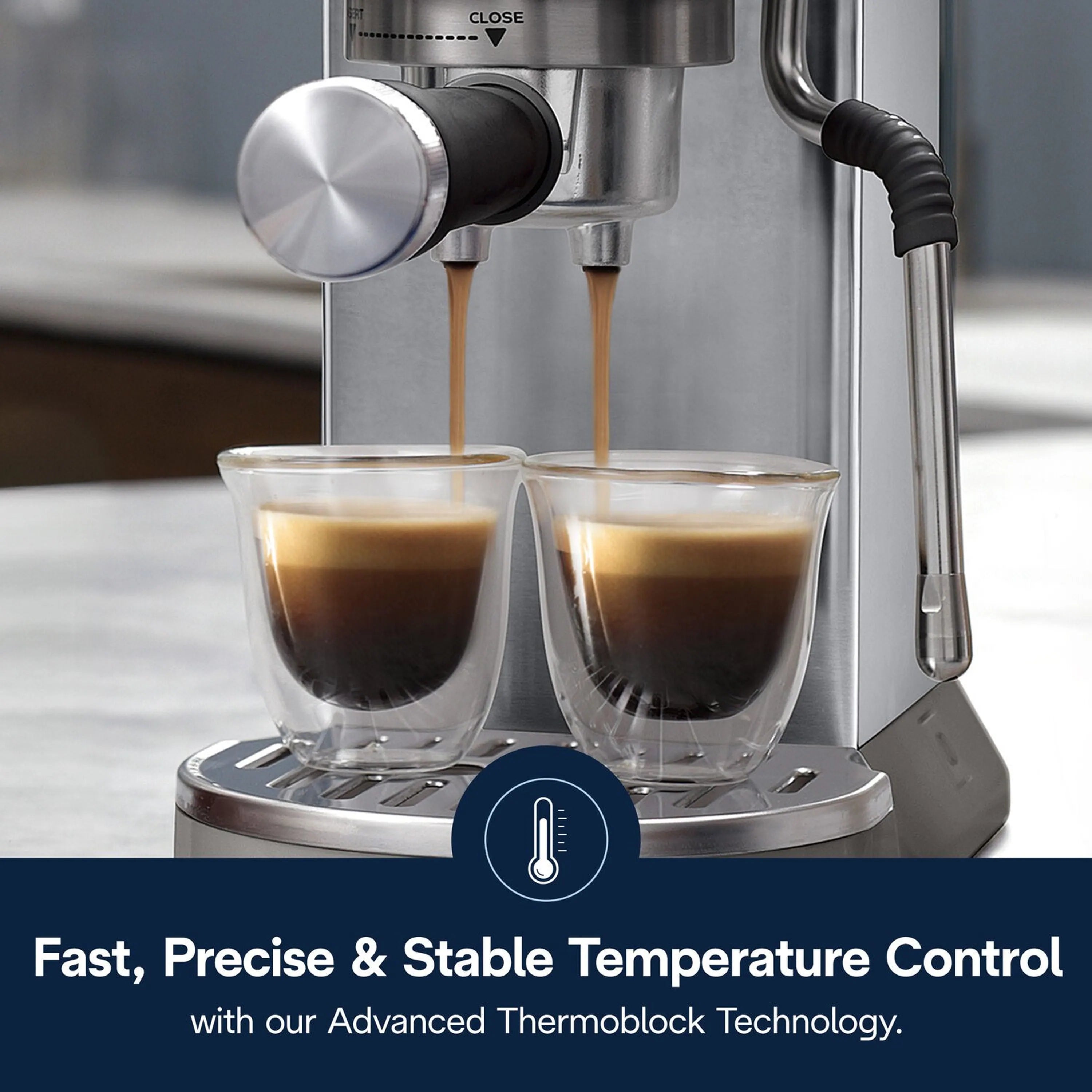 Stainless espresso machine spouts pouring into two clear cups