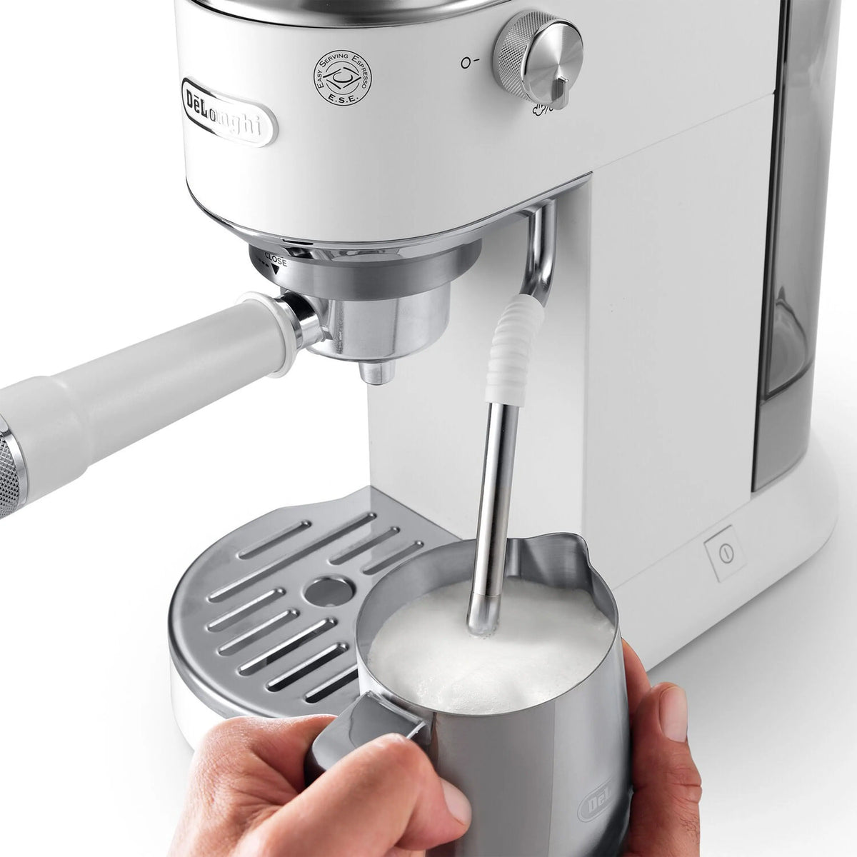 Espresso machine portafilter area with hands adjusting the tamper tool, stainless and white