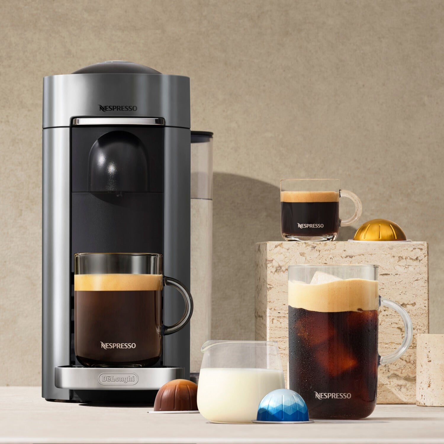 Titanium Vertuo Plus coffee machine with milk frother cup and glass espresso mug