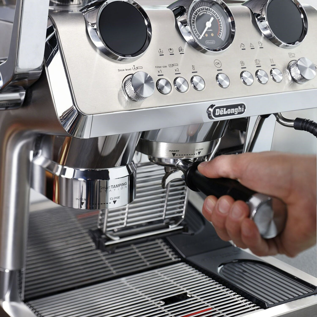 Stainless steel espresso machine group head with portafilter being inserted