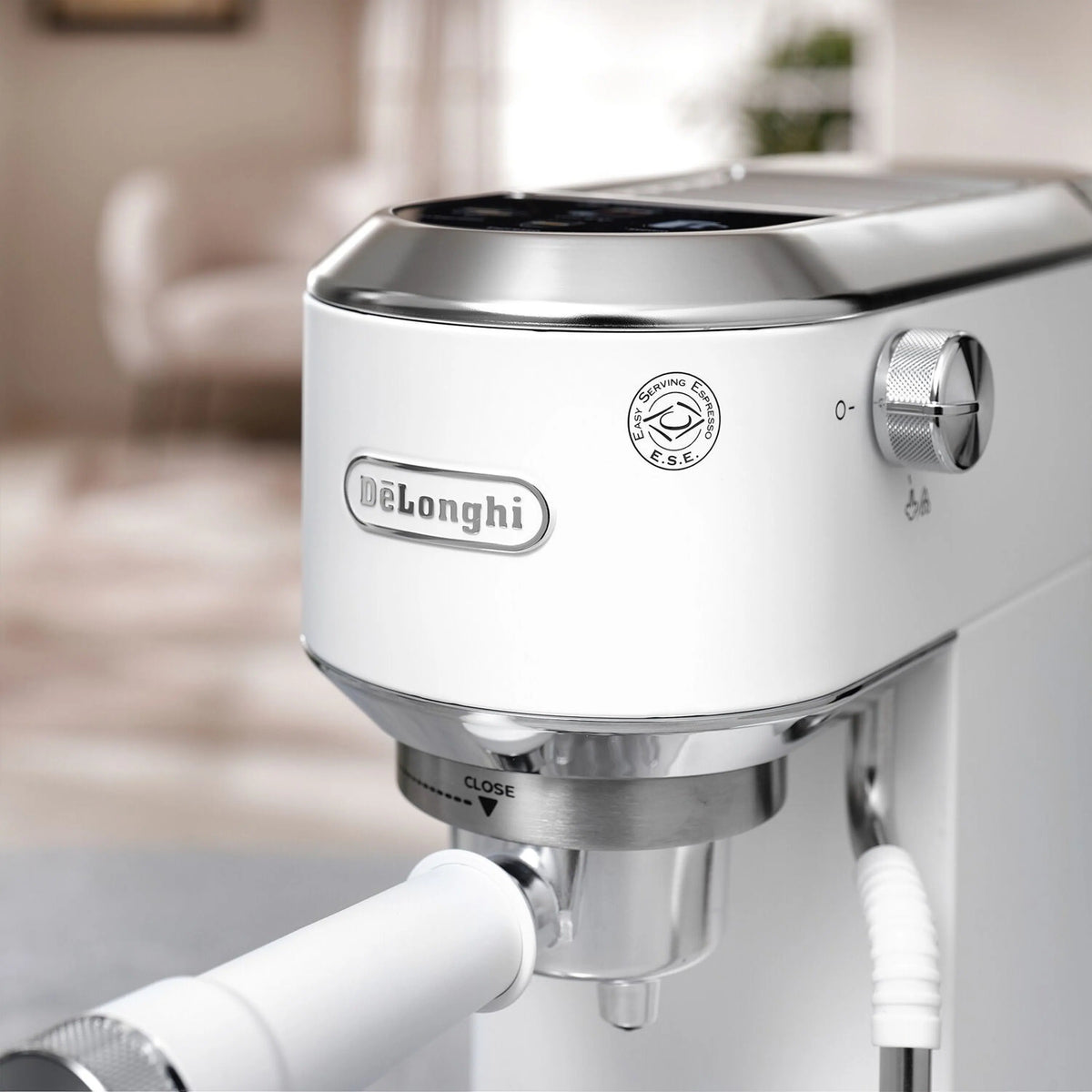 De'Longhi espresso machine front control dial and steam nozzle, white with stainless accents