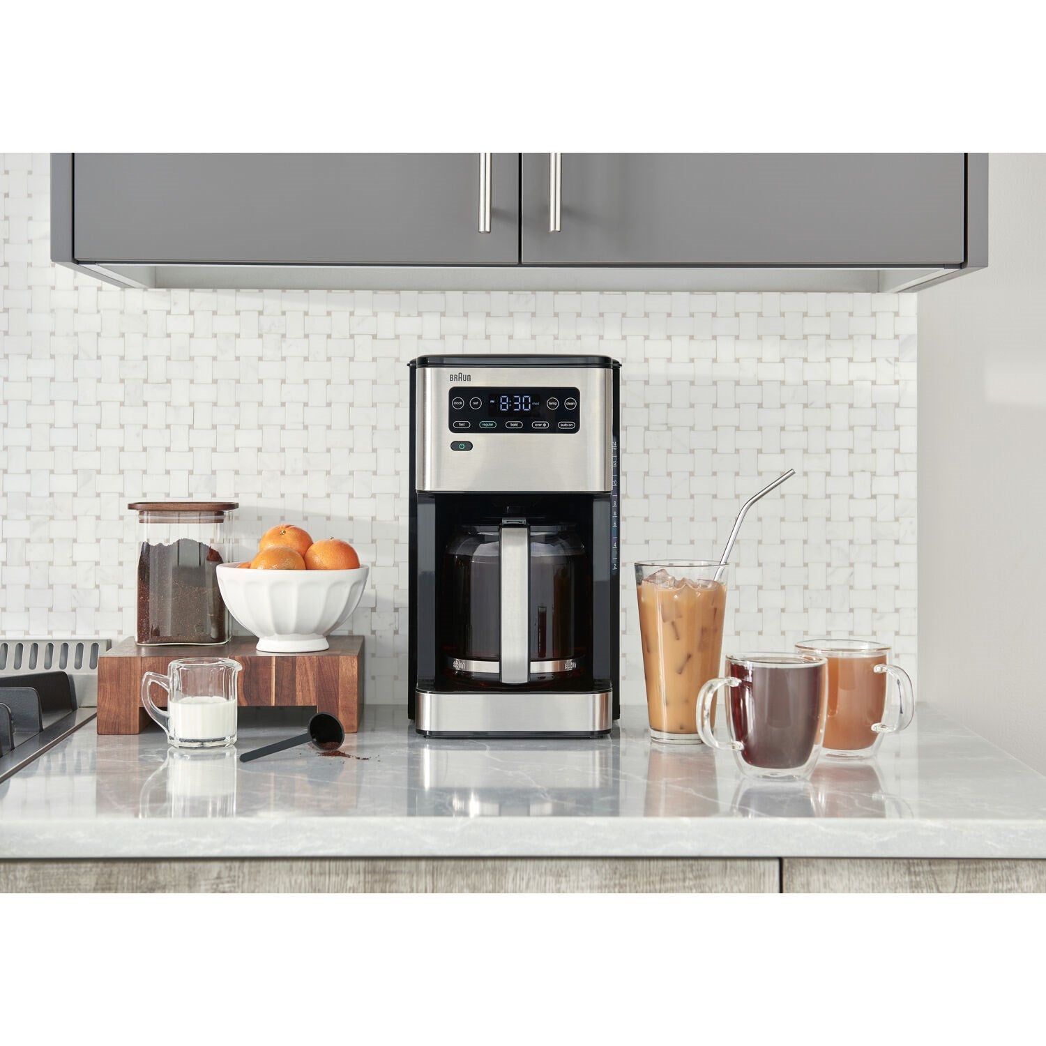Braun iced coffee maker on kitchen counter with cups and jug nearby