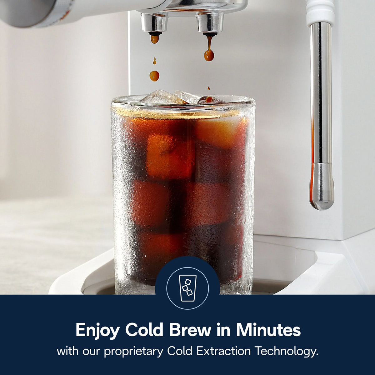 Espresso machine dispensing into a clear glass with ice cubes, dark coffee over ice