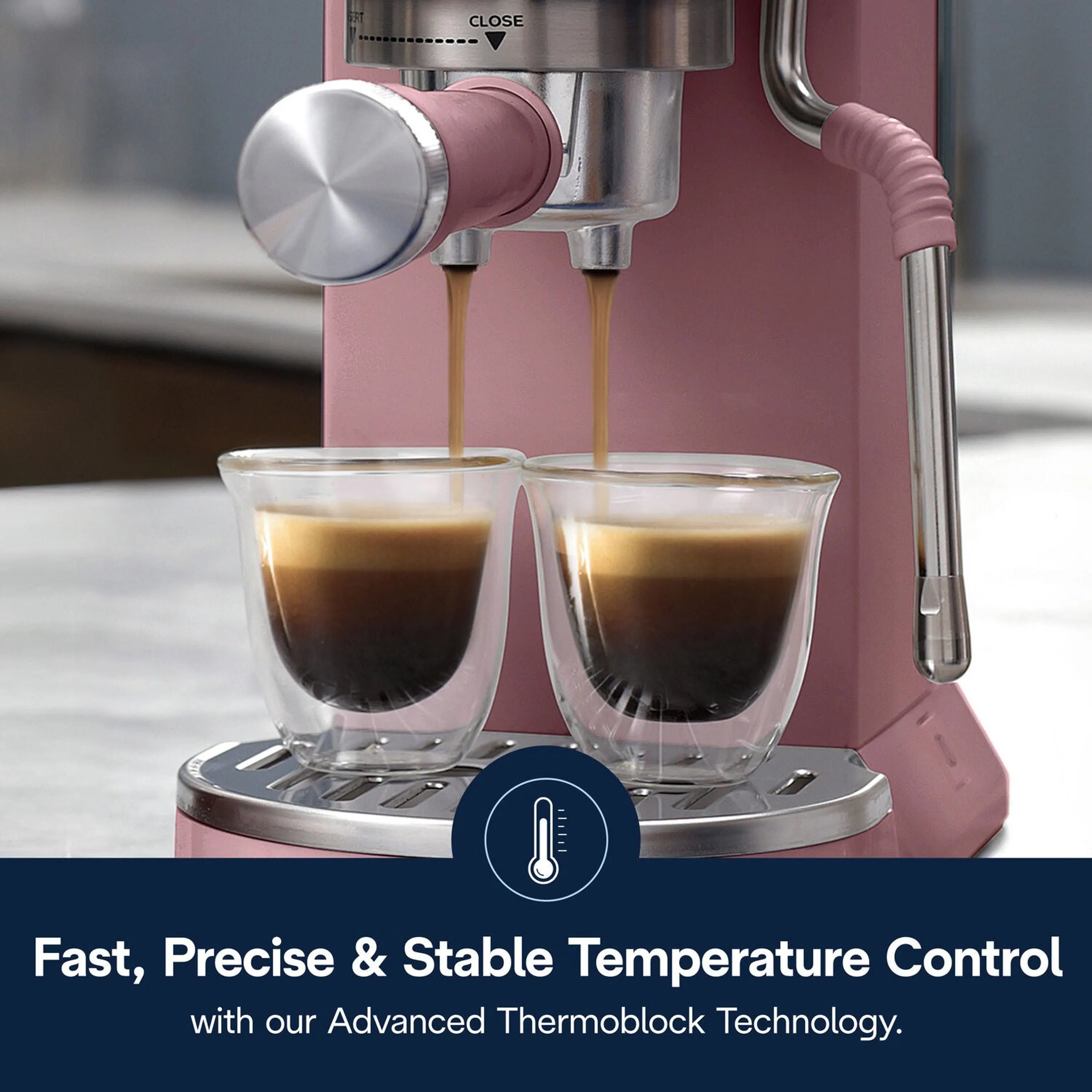 Pink De'Longhi pump espresso machine with two coffee cups beneath twin spouts