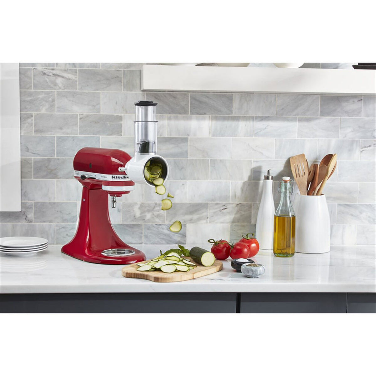 KitchenAid Fresh Prep slicer/shredder attachment on red stand mixer with sliced vegetables