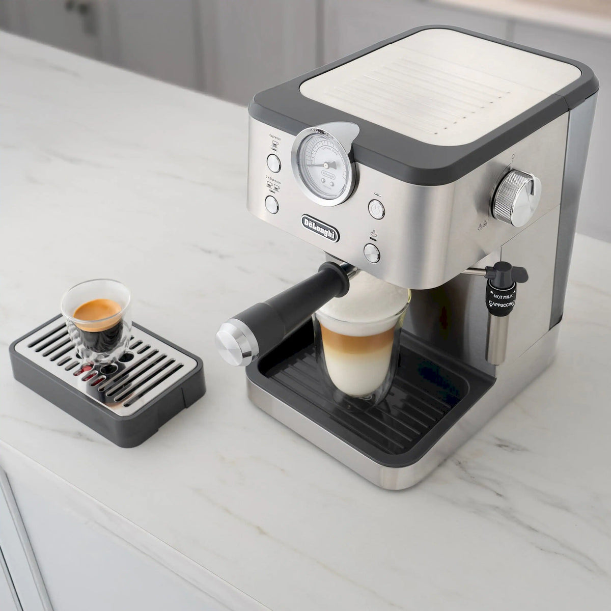Espresso machine with milk frother and adjustable drip tray, serving a layered drink.