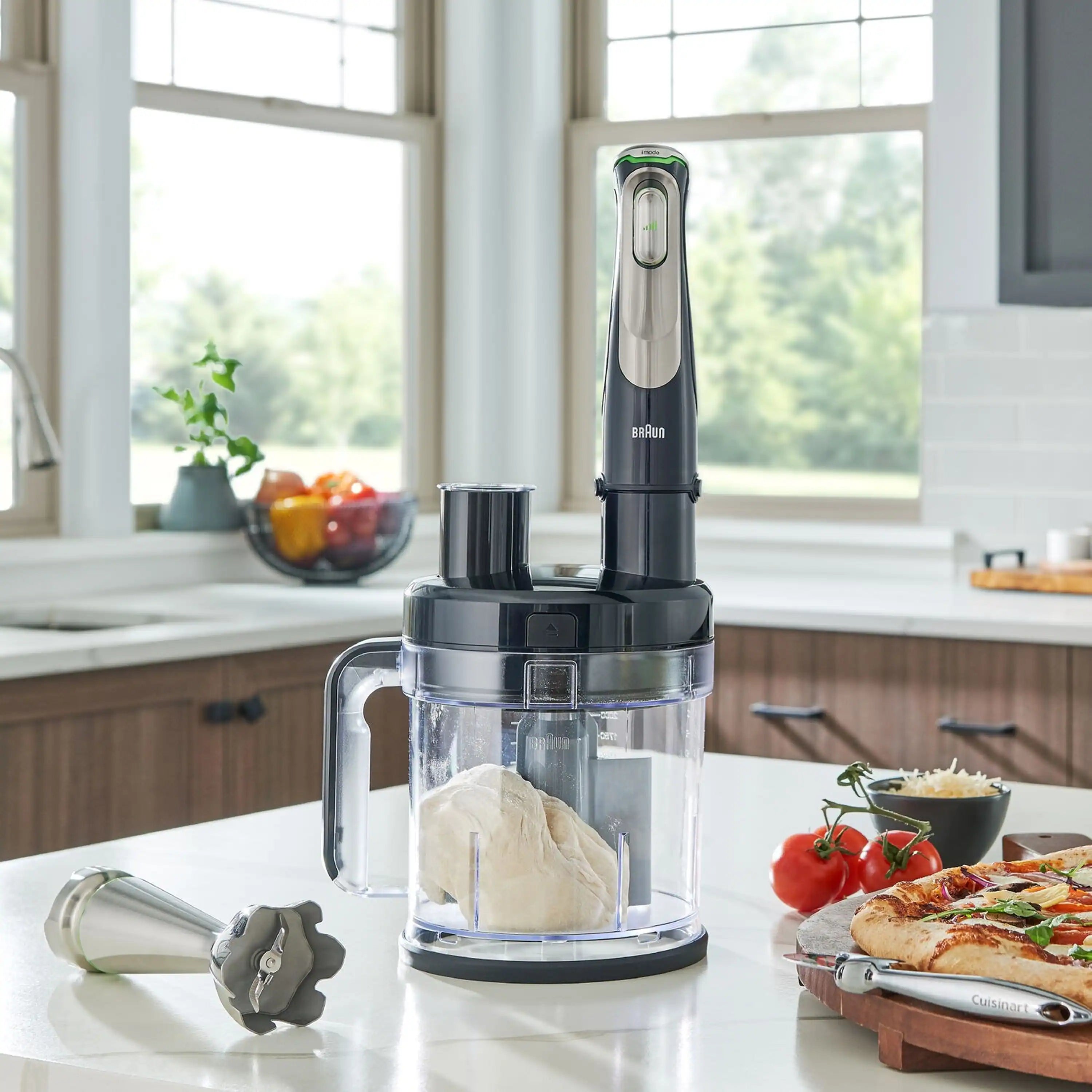 Braun SmartSpeed hand blender on clear processor base with mixing bowl and tools