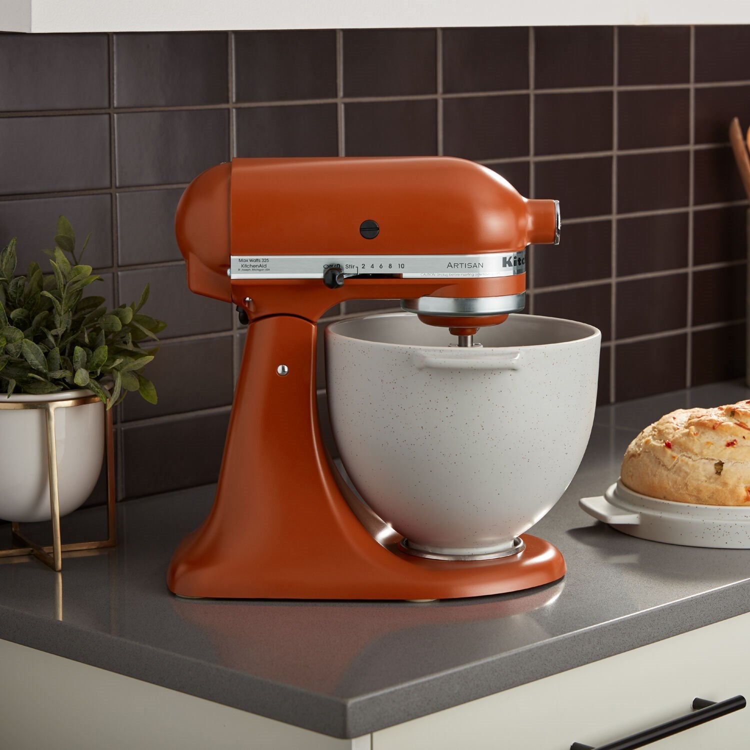 Scorched orange KitchenAid Artisan tilt-head stand mixer with bowl and flat beater