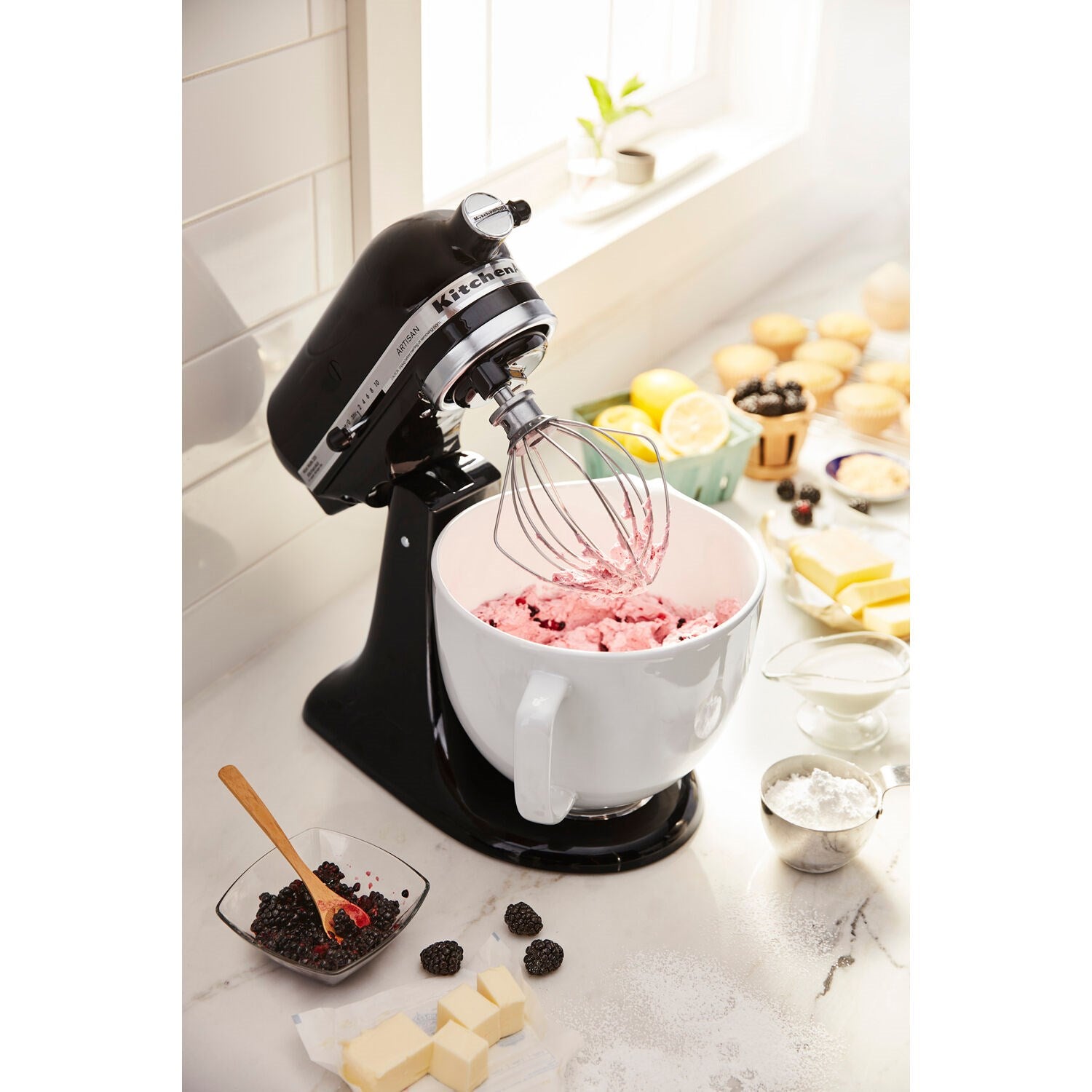 KitchenAid 5-quart ceramic mixing bowl in white, mounted on black stand mixer