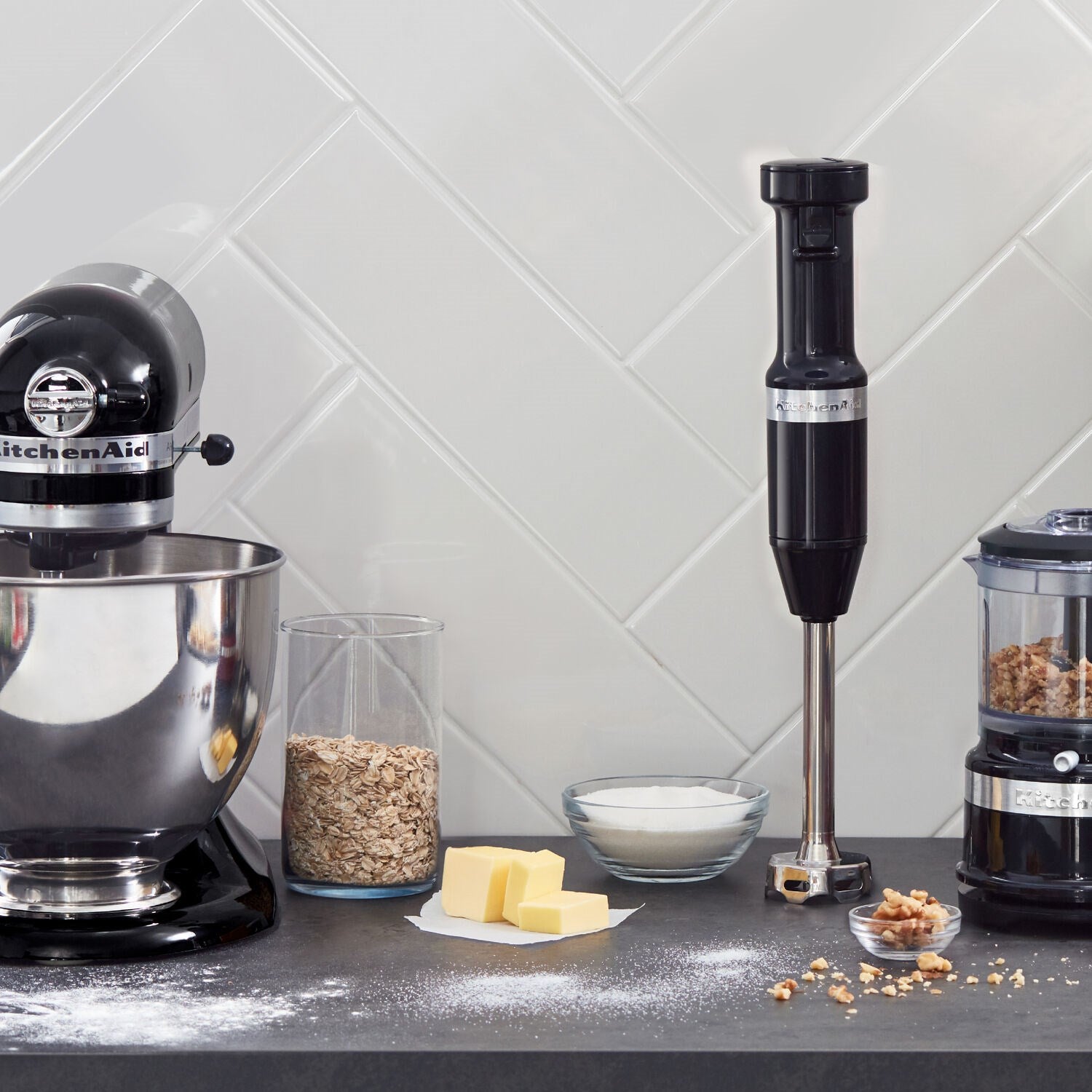 Onyx black immersion blender with blending cup and ingredients on countertop